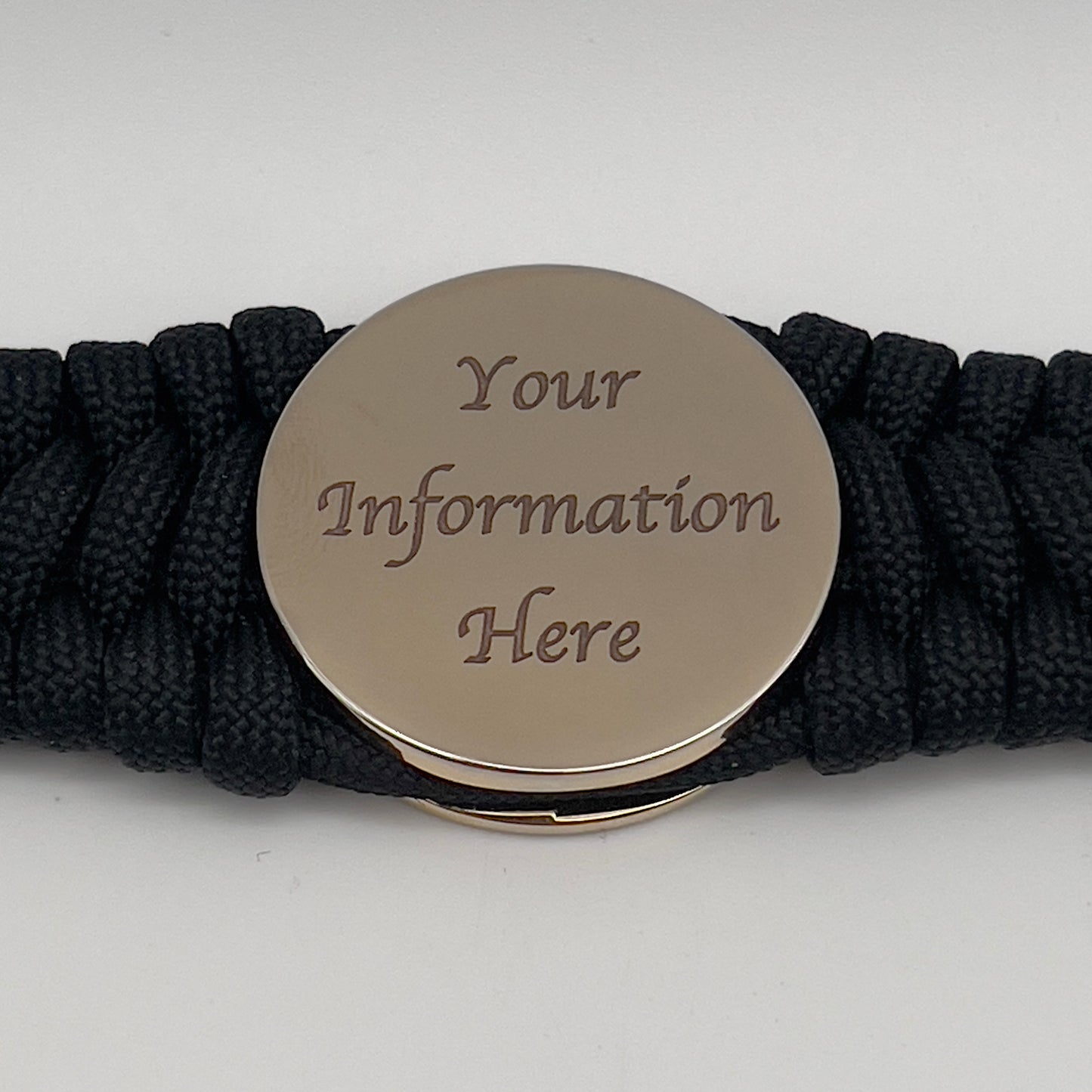 Thick, wide, rigid and comfortable braided United States Marine Corps bracelet featuring a 24K gold plated USMC Eagle Globe and Anchor medallion, a black Cobra style tactical buckle and woven with black 550 paracord.