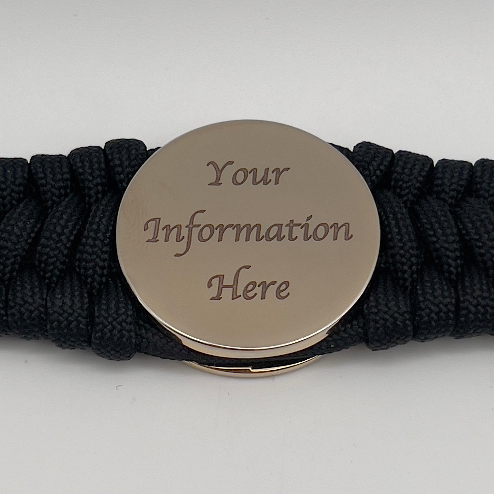 Thick, wide, rigid and comfortable braided United States Marine Corps bracelet featuring a 24K gold plated USMC Eagle Globe and Anchor medallion, a black Cobra style tactical buckle and woven with black 550 paracord.