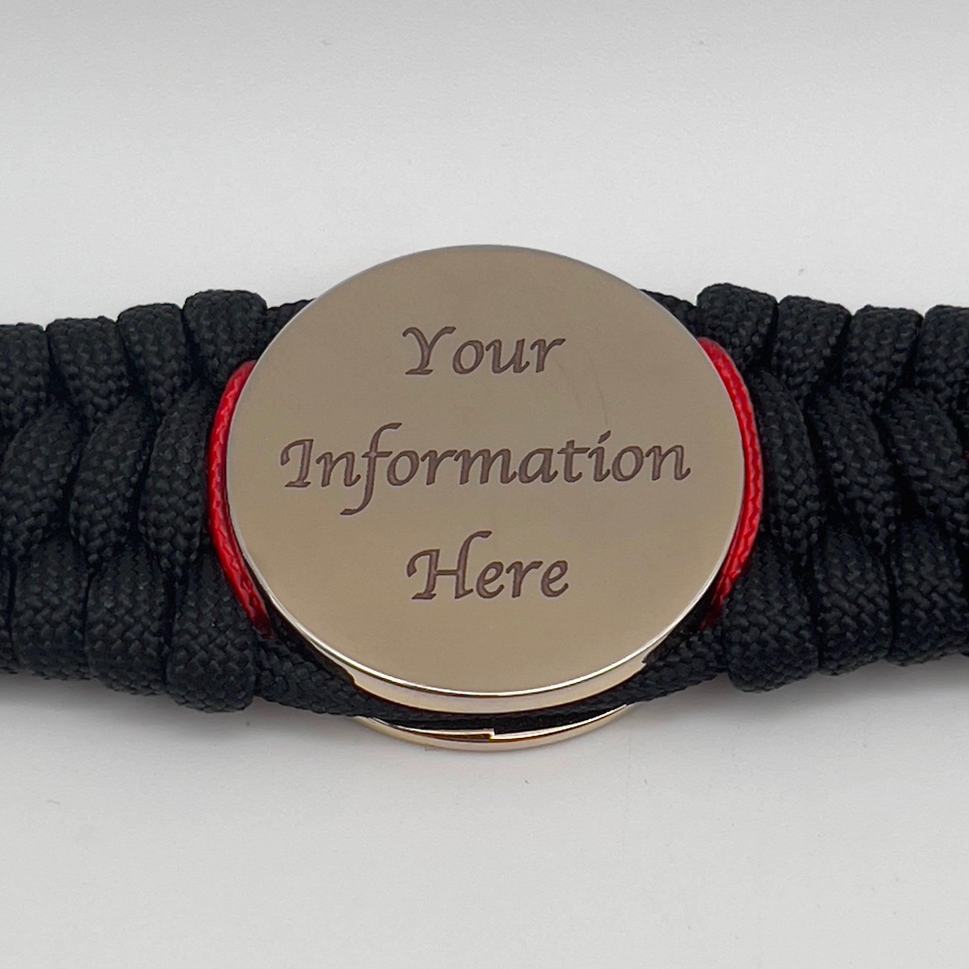 Thick, wide, rigid and comfortable braided United States Marine Corps bracelet featuring a 24K gold plated USMC Eagle Globe and Anchor medallion, a black Cobra style tactical buckle and woven with black 550 paracord and Imperial Red nano and micro cord.
