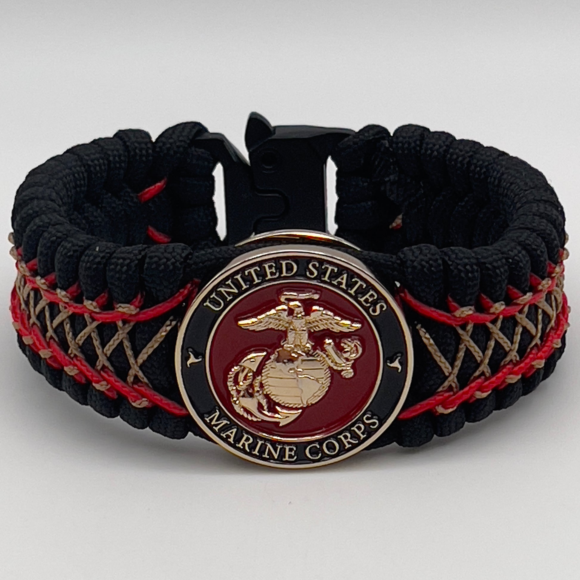 Thick, wide, rigid and comfortable braided United States Marine Corps bracelet featuring a 24K gold plated USMC Eagle Globe and Anchor medallion, a black Cobra style tactical buckle and woven with black 550 paracord and Imperial Red micro and gold nano cord.