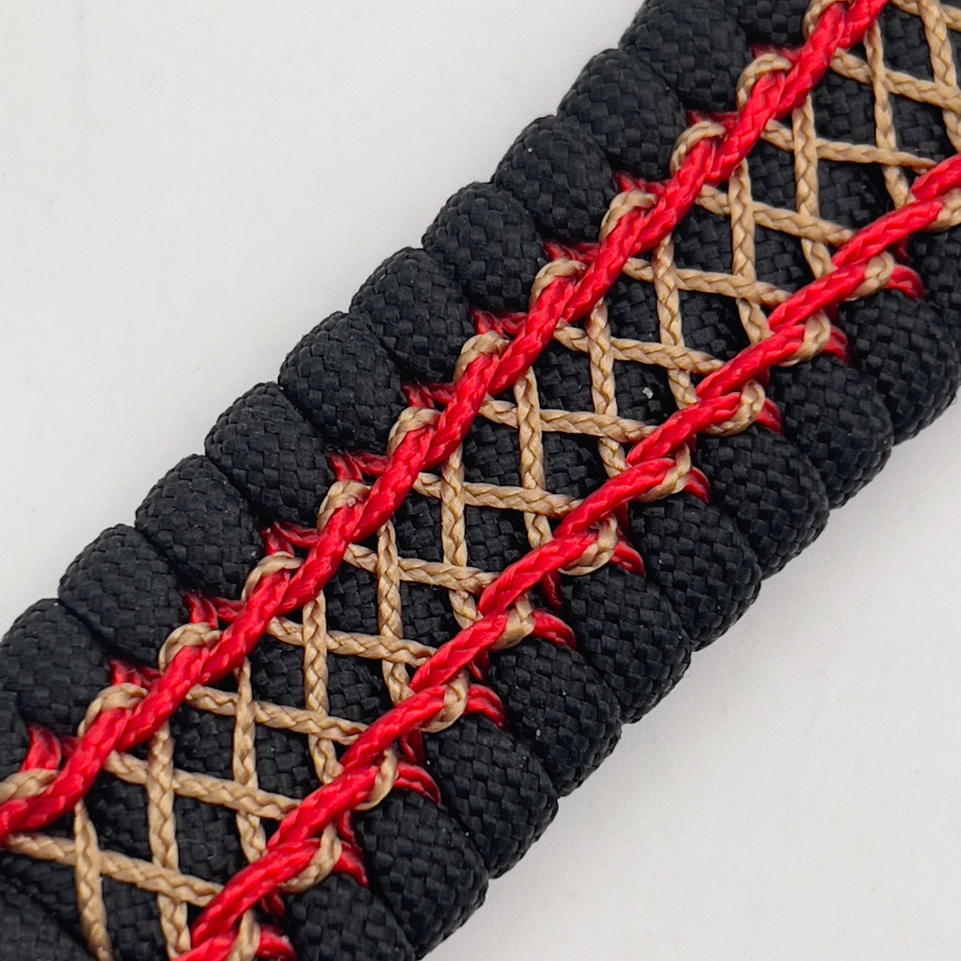 Thick, wide, rigid and comfortable braided United States Marine Corps bracelet featuring a 24K gold plated USMC Eagle Globe and Anchor medallion, a black Cobra style tactical buckle and woven with black 550 paracord and Imperial Red micro and gold nano cord.