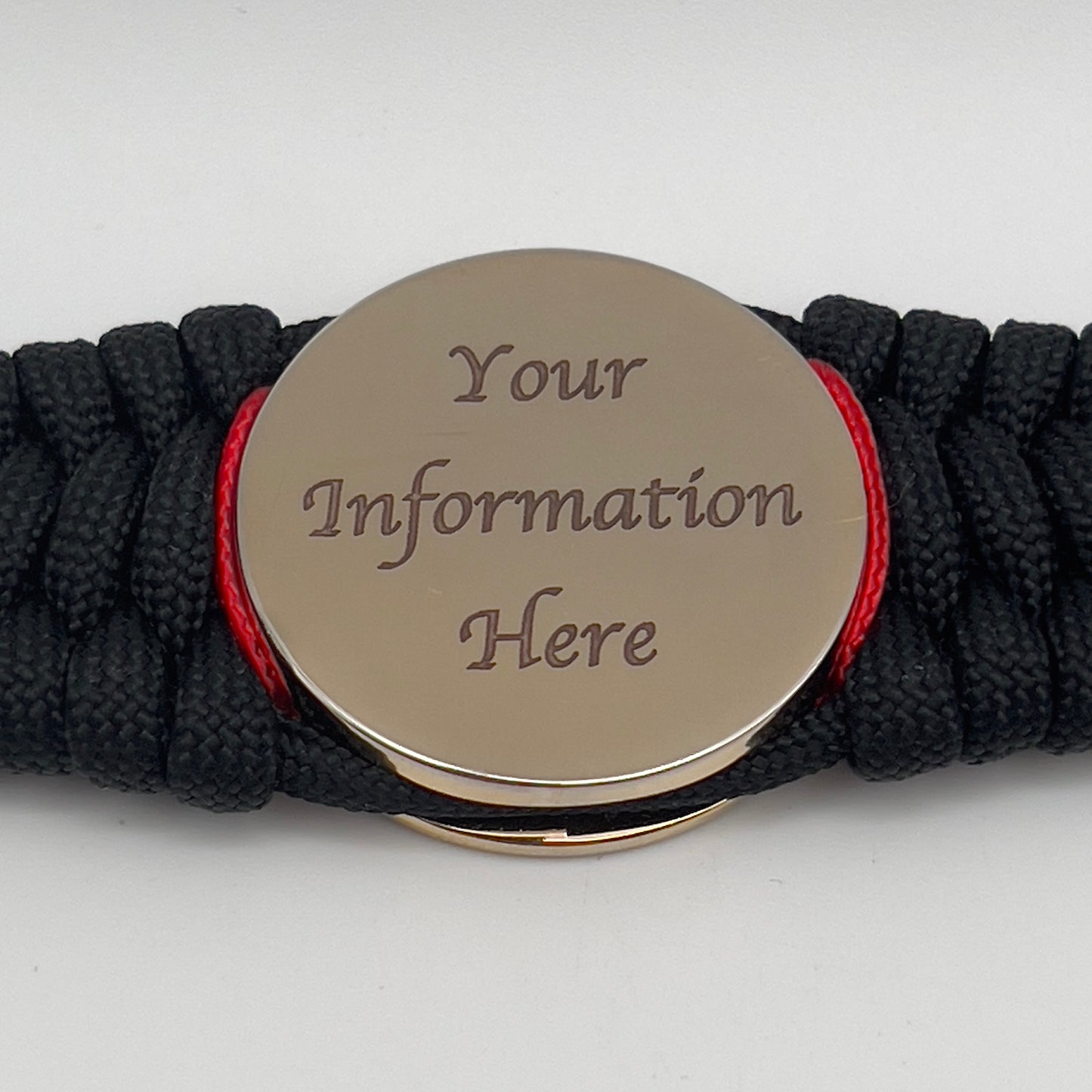 Thick, wide, rigid and comfortable braided United States Marine Corps bracelet featuring a 24K gold plated USMC Eagle Globe and Anchor medallion, a black Cobra style tactical buckle and woven with black 550 paracord and Imperial Red micro and gold nano cord.