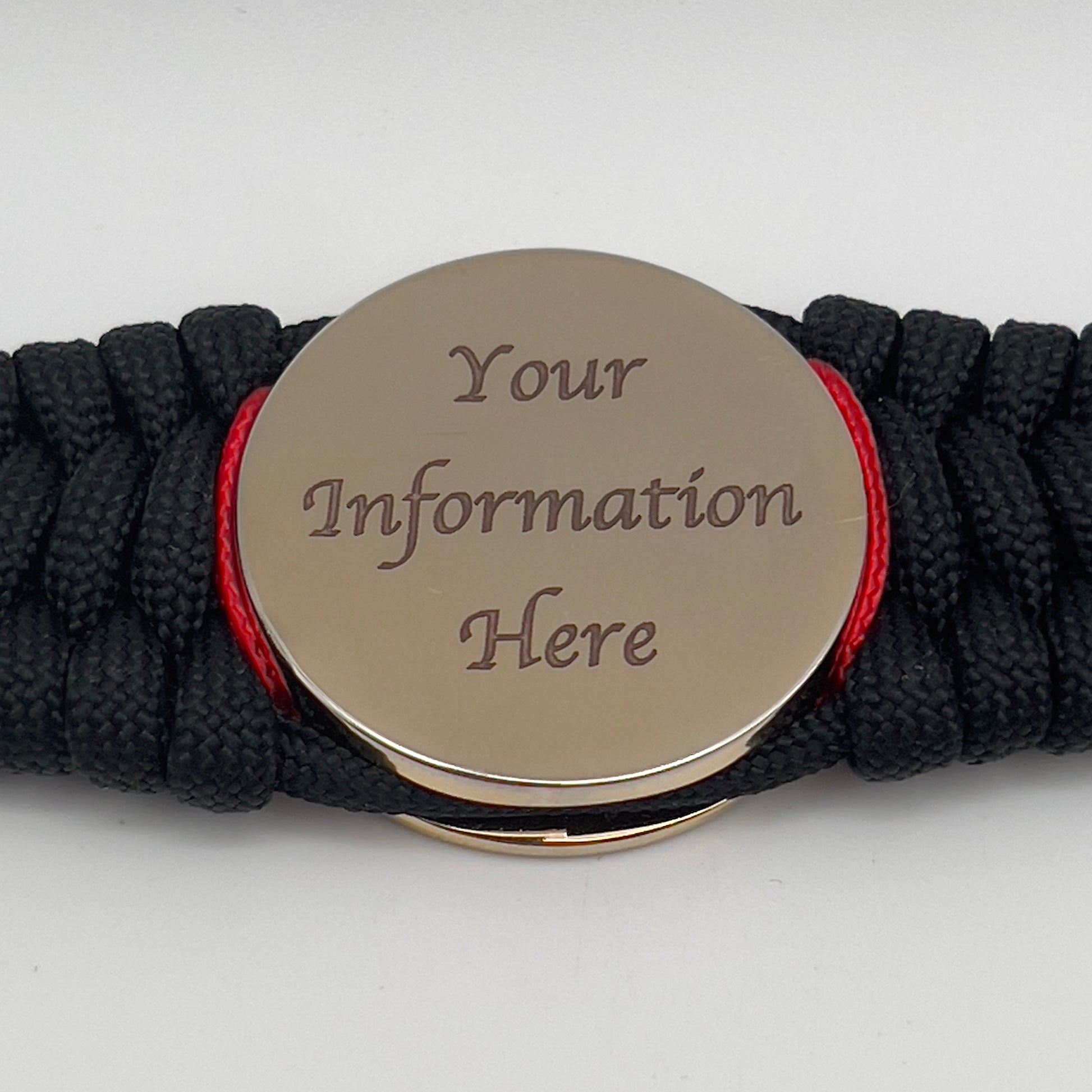 Thick, wide, rigid and comfortable braided United States Marine Corps bracelet featuring a 24K gold plated USMC Eagle Globe and Anchor medallion, a black Cobra style tactical buckle and woven with black 550 paracord and Imperial Red micro and gold nano cord.