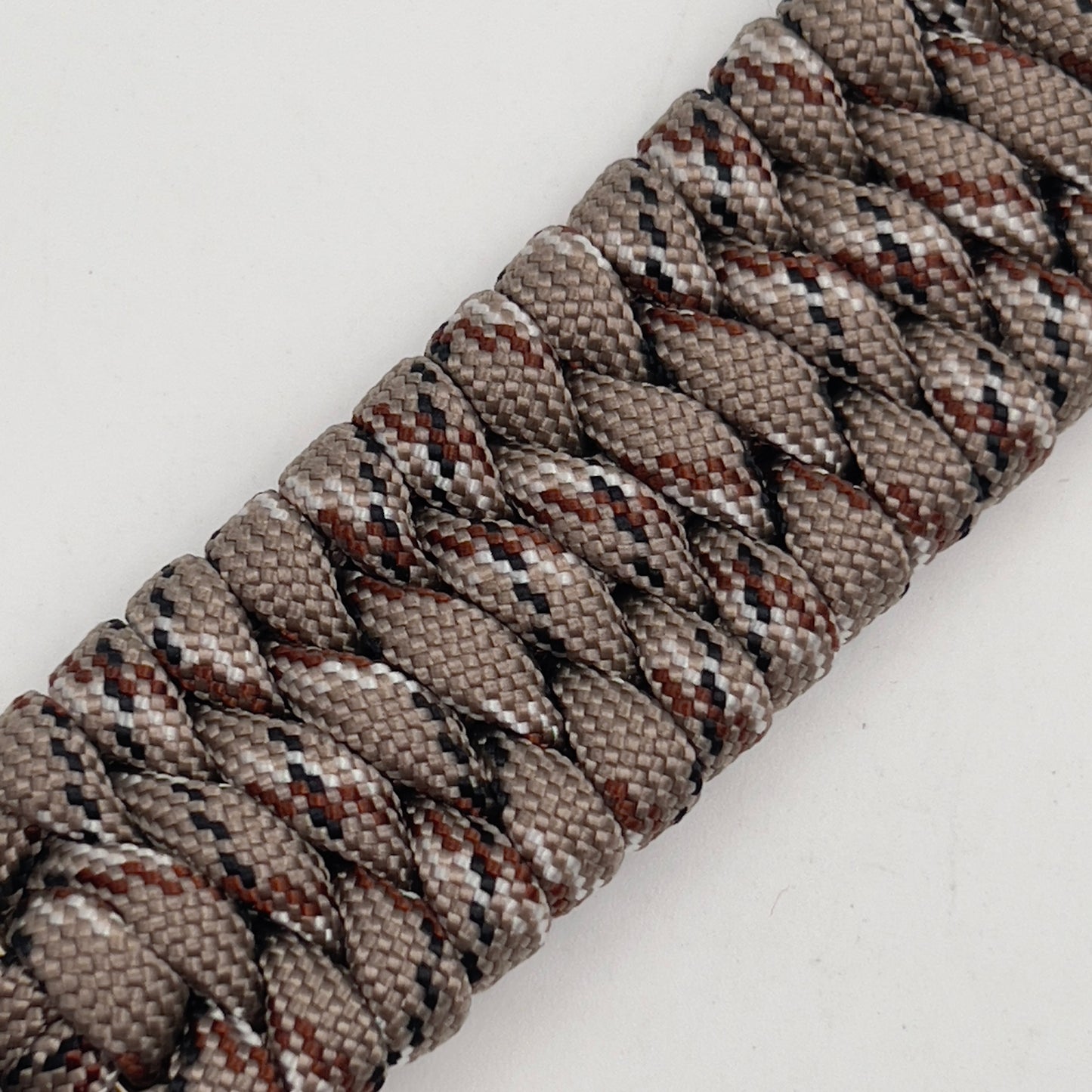 Thick, wide, semi-rigid and comfortable braided United States Marine Corps bracelet featuring a 24K gold plated USMC Eagle Globe and Anchor medallion, a gold Cobra style tactical buckle and woven with Desert Camo 550 paracord.
