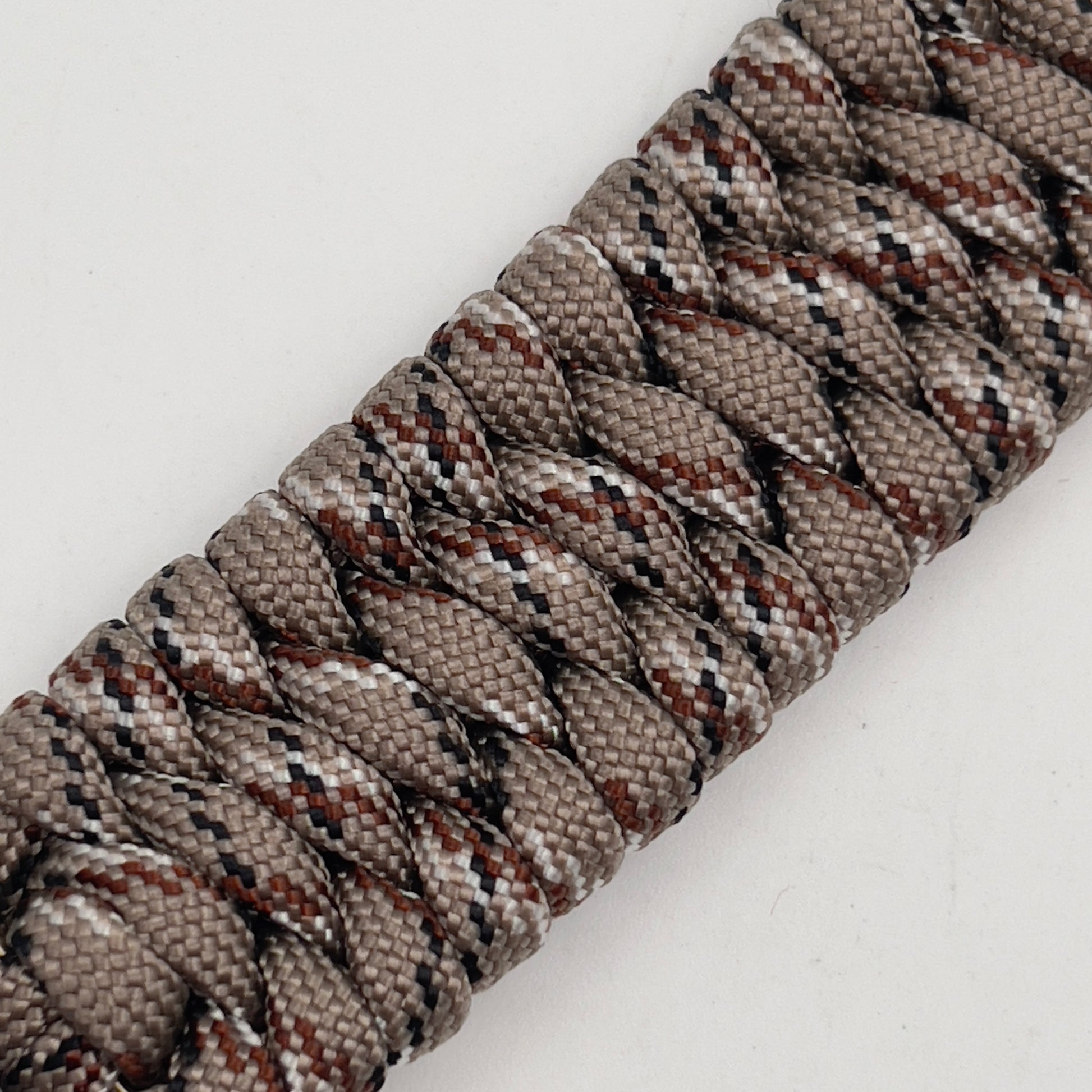 Thick, wide, semi-rigid and comfortable braided United States Marine Corps bracelet featuring a 24K gold plated USMC Eagle Globe and Anchor medallion, a gold Cobra style tactical buckle and woven with Desert Camo 550 paracord.