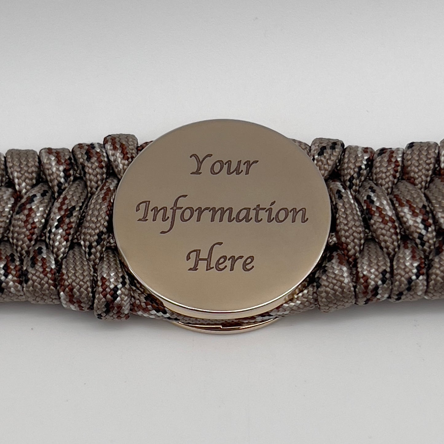 Thick, wide, semi-rigid and comfortable braided United States Marine Corps bracelet featuring a 24K gold plated USMC Eagle Globe and Anchor medallion, a gold Cobra style tactical buckle and woven with Desert Camo 550 paracord.