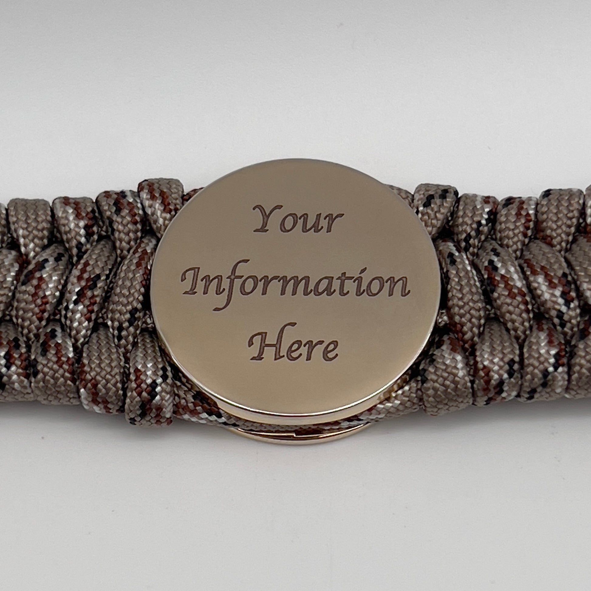 Thick, wide, semi-rigid and comfortable braided United States Marine Corps bracelet featuring a 24K gold plated USMC Eagle Globe and Anchor medallion, a gold Cobra style tactical buckle and woven with Desert Camo 550 paracord.