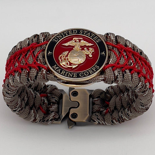 Thick, wide, rigid and comfortable braided United States Marine Corps bracelet featuring a 24K gold plated USMC Eagle Globe and Anchor medallion, a gold Cobra style tactical buckle and woven with Desert Camo 550 paracord and Imperial Red nano and micro cord.