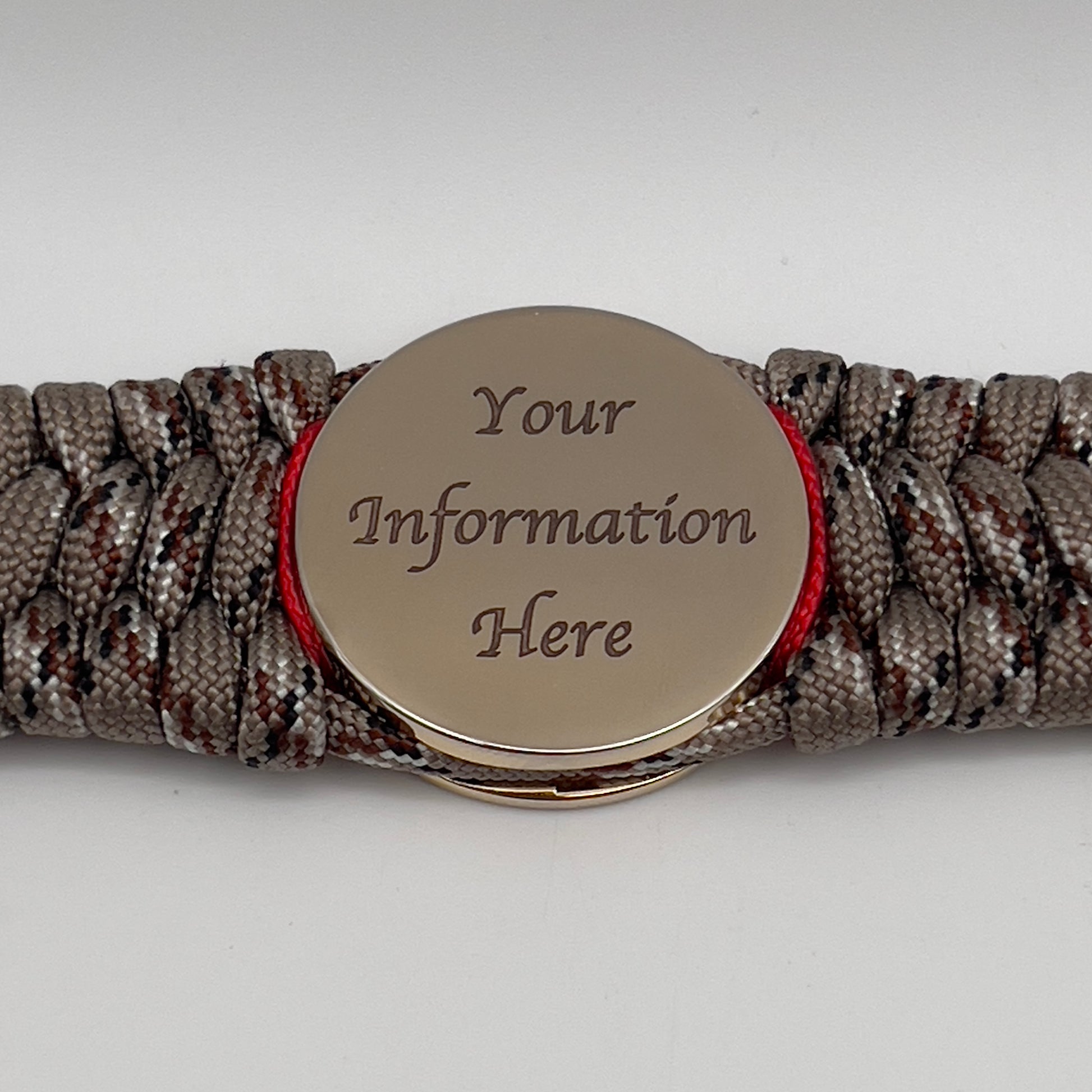 Thick, wide, rigid and comfortable braided United States Marine Corps bracelet featuring a 24K gold plated USMC Eagle Globe and Anchor medallion, a gold Cobra style tactical buckle and woven with Desert Camo 550 paracord and Imperial Red nano and micro cord.