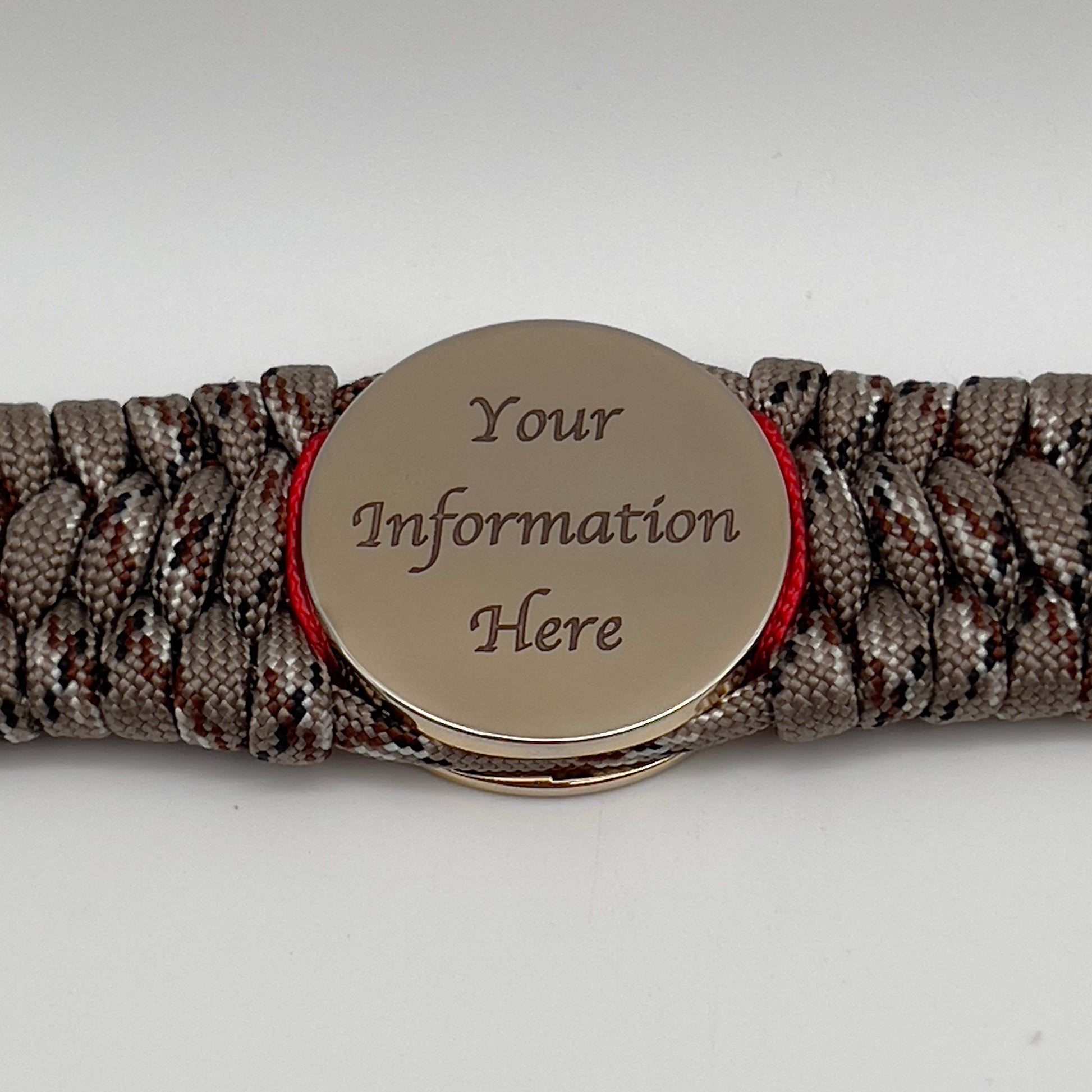 Thick, wide, rigid and comfortable braided United States Marine Corps bracelet featuring a 24K gold plated USMC Eagle Globe and Anchor medallion, a gold Cobra style tactical buckle and woven with Desert Camo 550 paracord and Imperial Red micro and gold nano cord.