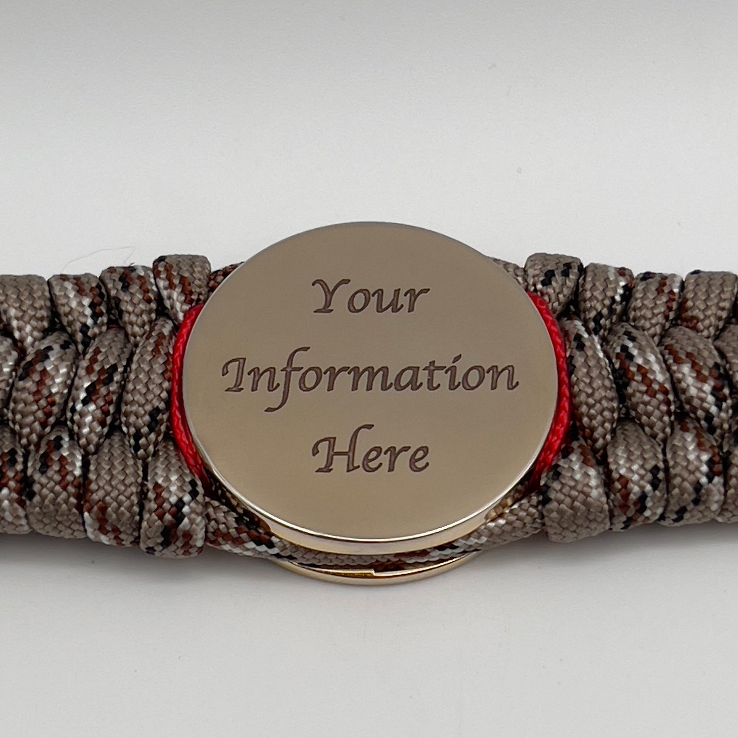 Thick, wide, rigid and comfortable braided United States Marine Corps bracelet featuring a 24K gold plated USMC Eagle Globe and Anchor medallion, a gold Cobra style tactical buckle and woven with Desert Camo 550 paracord, Imperial Red micro cord and black nano cord.