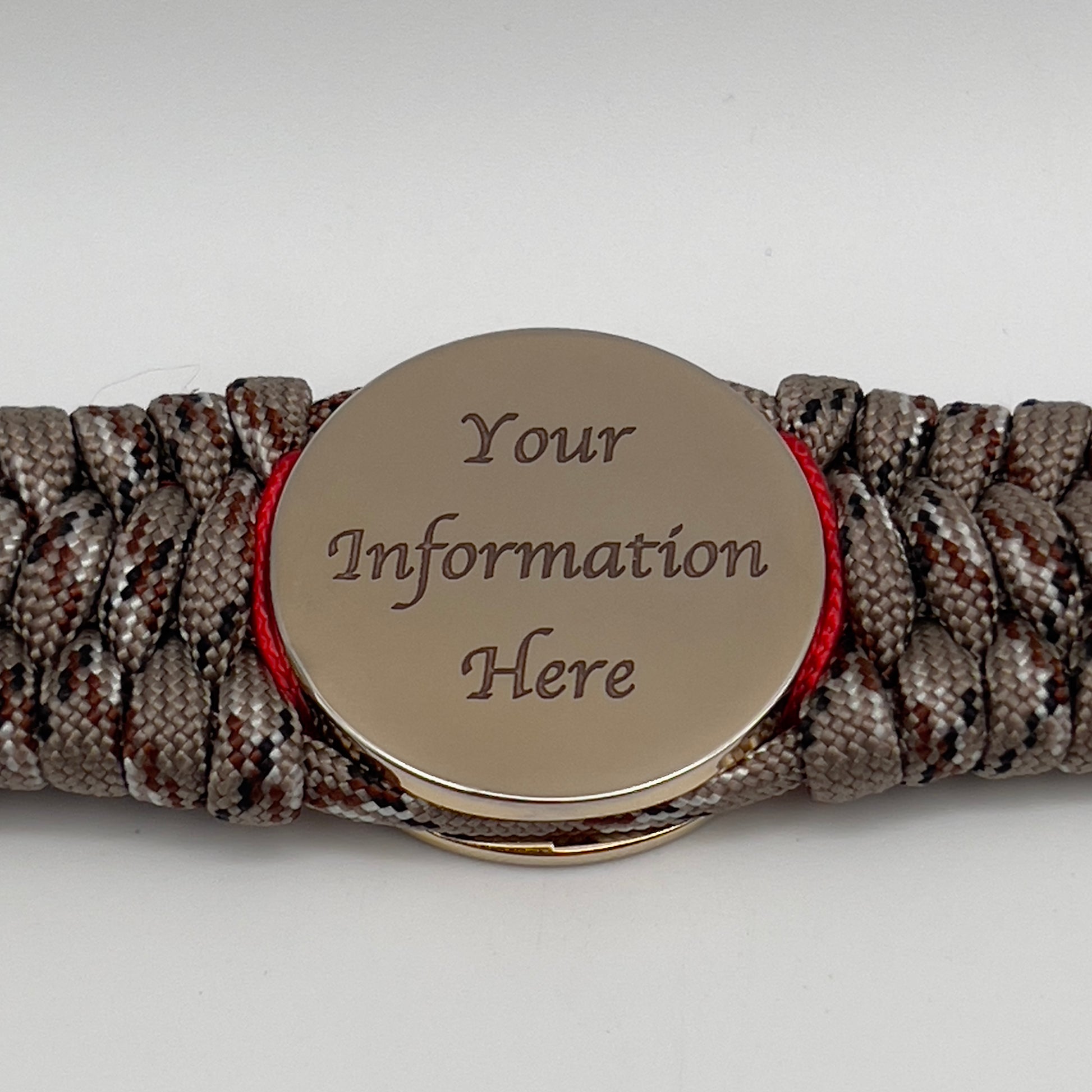 Thick, wide, rigid and comfortable braided United States Marine Corps bracelet featuring a 24K gold plated USMC Eagle Globe and Anchor medallion, a gold Cobra style tactical buckle and woven with Desert Camo 550 paracord, Imperial Red micro cord and black nano cord.