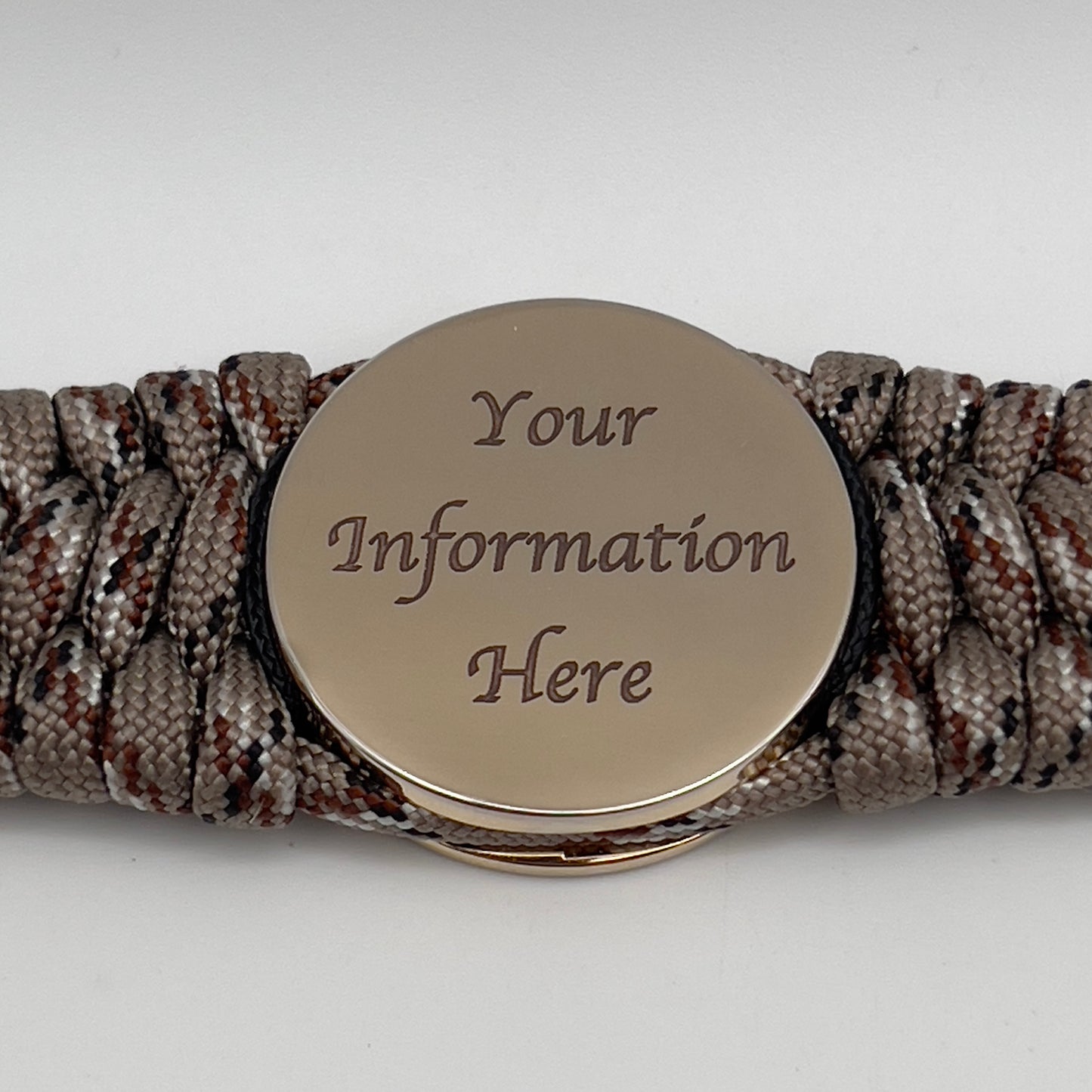 Thick, wide, rigid and comfortable braided United States Marine Corps bracelet featuring a 24K gold plated USMC Eagle Globe and Anchor medallion, a gold Cobra style tactical buckle and woven with Desert Camo 550 paracord, black micro cord and Imperial Red nano cord.