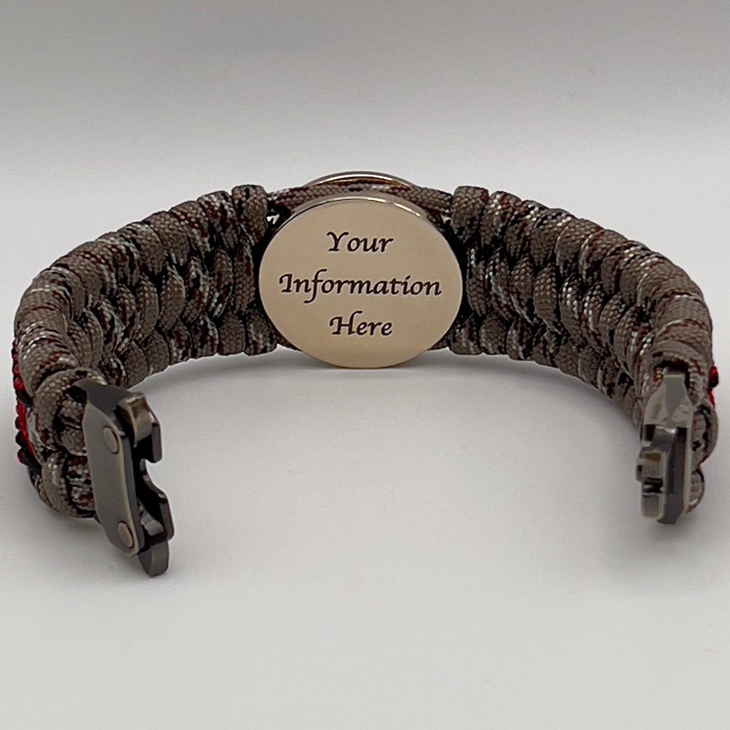 Thick, wide, rigid and comfortable braided United States Marine Corps bracelet featuring a 24K gold plated USMC Eagle Globe and Anchor medallion, a gold Cobra style tactical buckle and woven with Desert Camo 550 paracord, black micro cord and Imperial Red nano cord.
