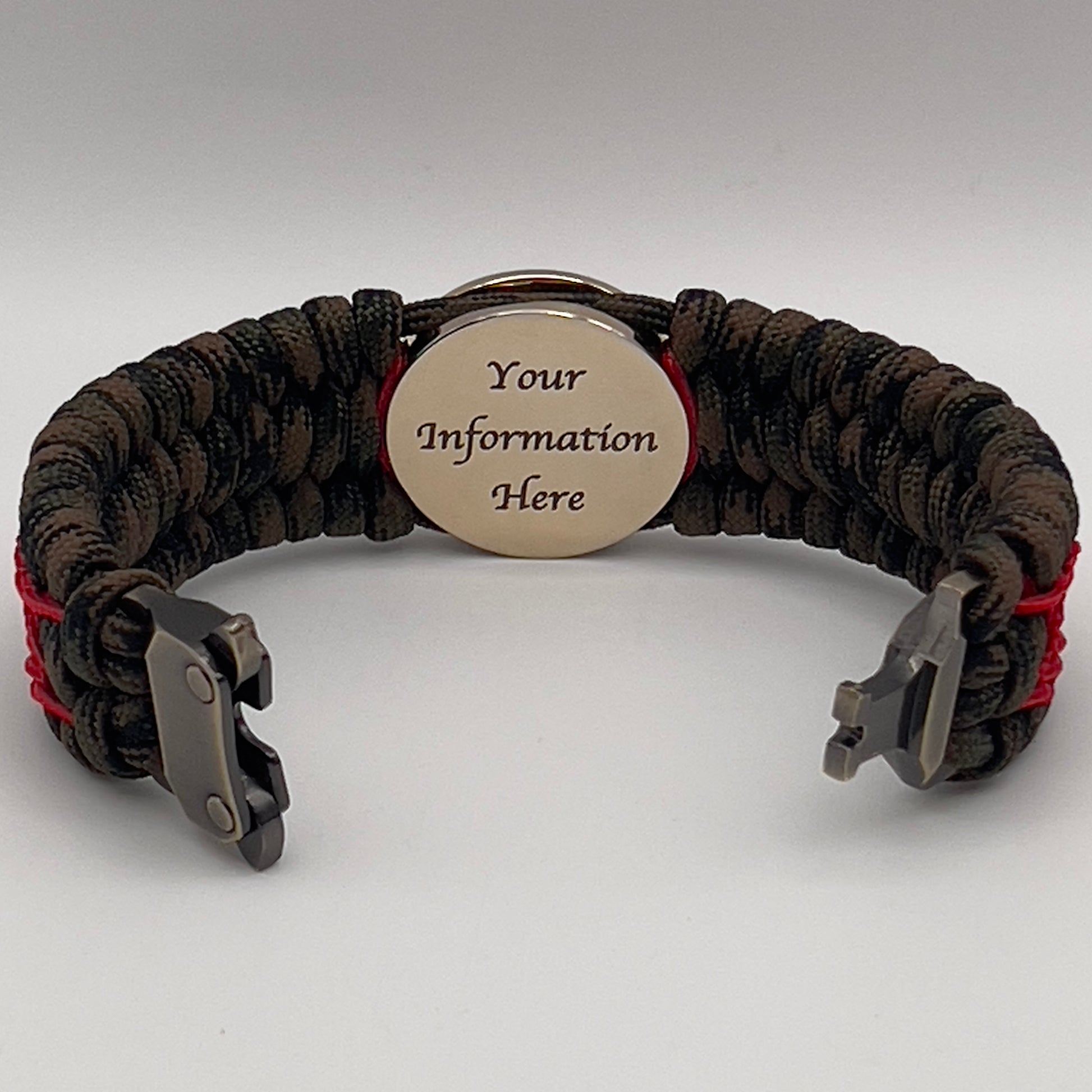 Thick, wide, rigid and comfortable braided United States Marine Corps bracelet featuring a 24K gold plated USMC Eagle Globe and Anchor medallion, a gold Cobra style tactical buckle and woven with Woodland Camo 550 paracord and Imperial Red nano and micro cord.