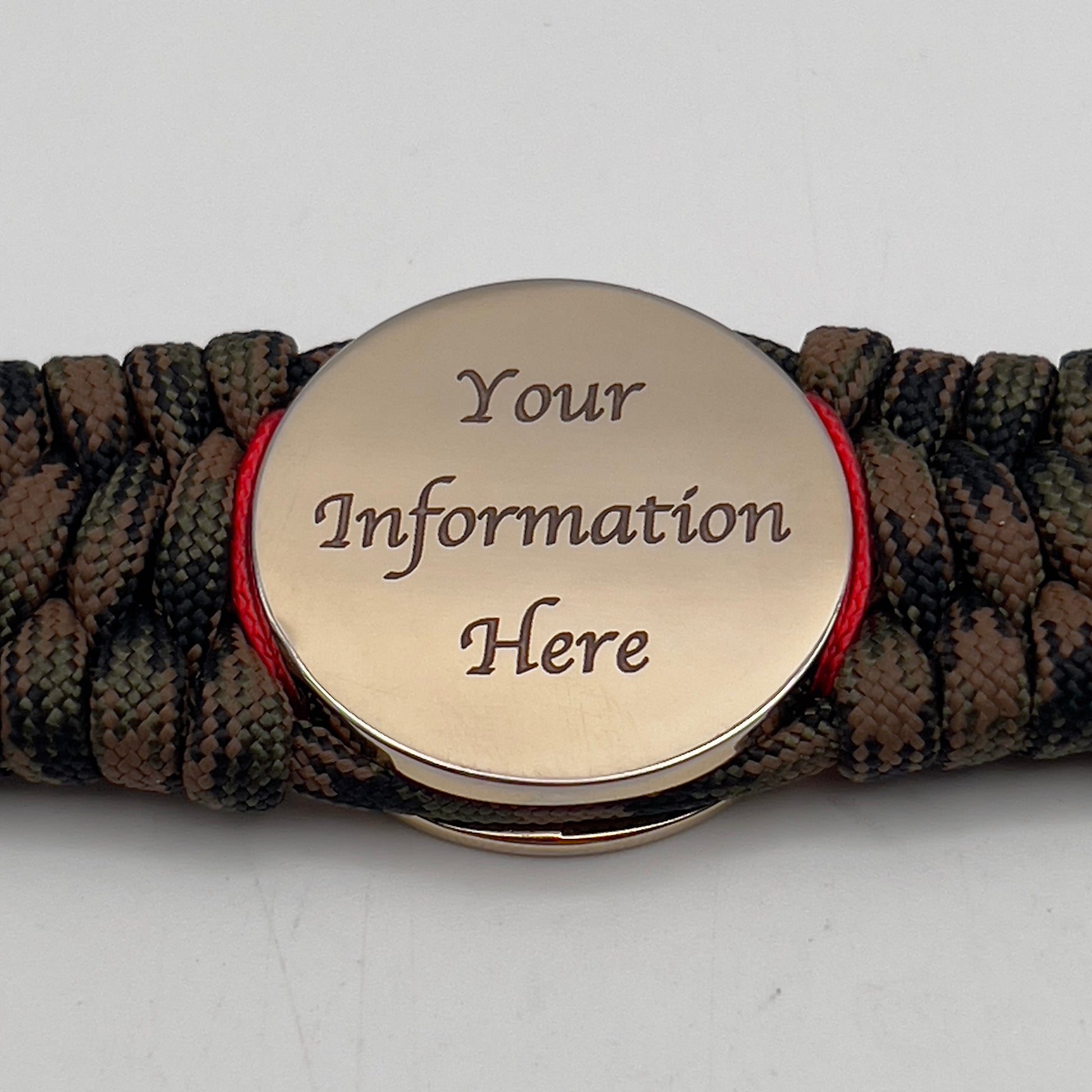 Thick, wide, rigid and comfortable braided United States Marine Corps bracelet featuring a 24K gold plated USMC Eagle Globe and Anchor medallion, a gold Cobra style tactical buckle and woven with Woodland Camo 550 paracord and Imperial Red micro and black nano cord.