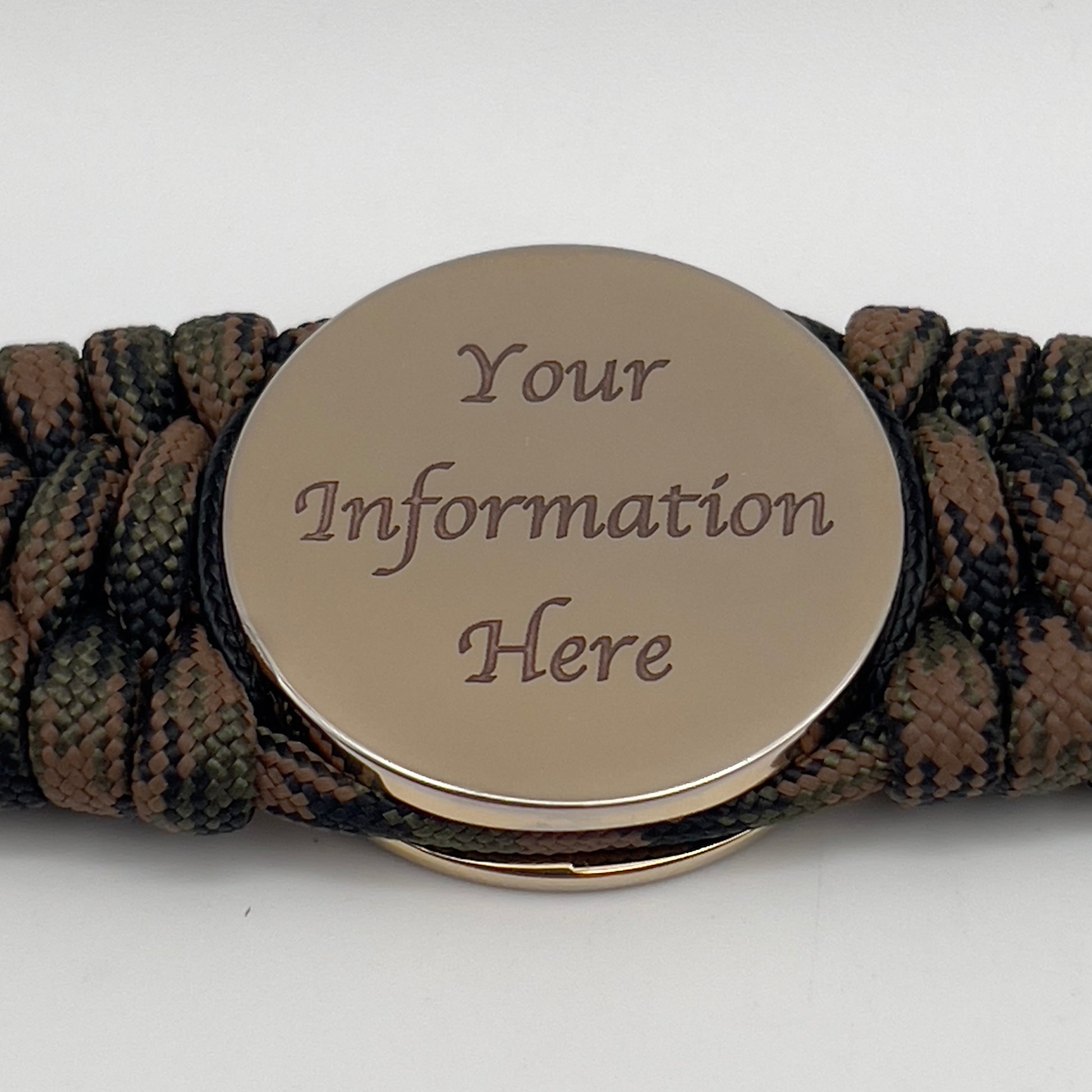 Thick, wide, rigid and comfortable braided United States Marine Corps bracelet featuring a 24K gold plated USMC Eagle Globe and Anchor medallion, a gold Cobra style tactical buckle and woven with Woodland Camo 550 paracord and black nano and micro cord.