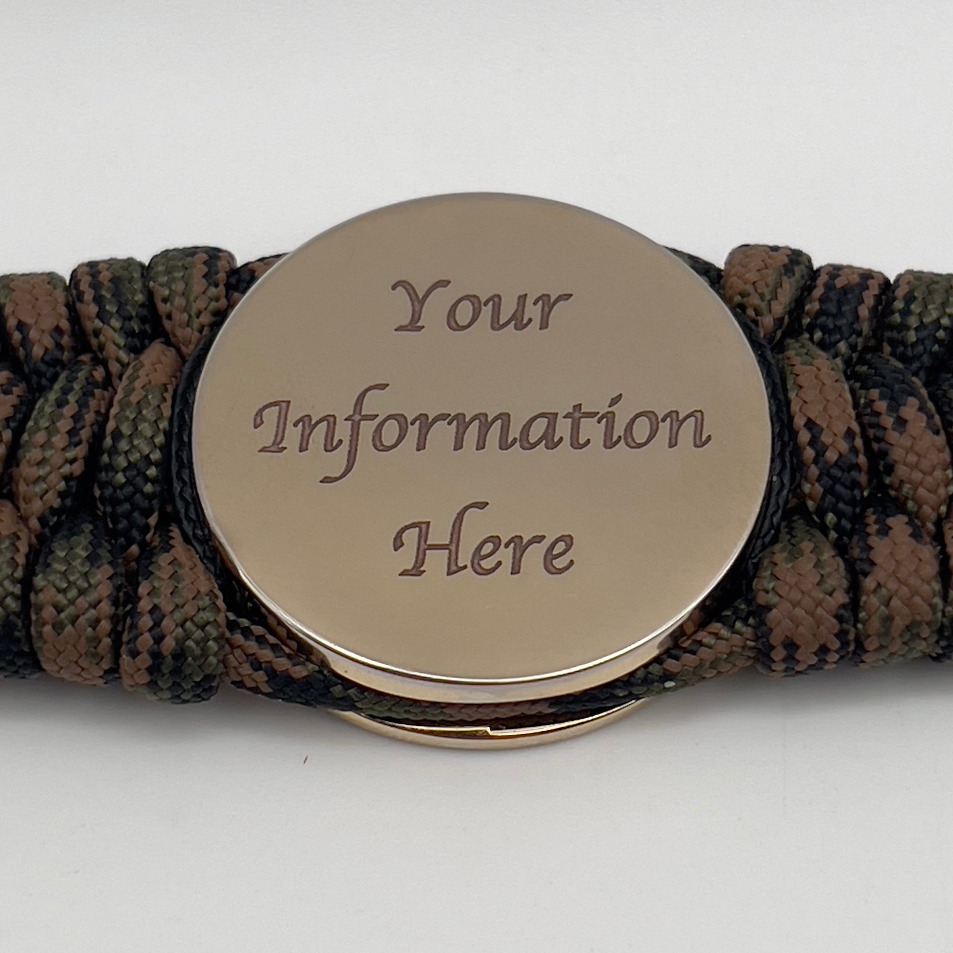 Thick, wide, rigid and comfortable braided United States Marine Corps bracelet featuring a 24K gold plated USMC Eagle Globe and Anchor medallion, a gold Cobra style tactical buckle and woven with Woodland 550 paracord, black micro and tan nano cord.