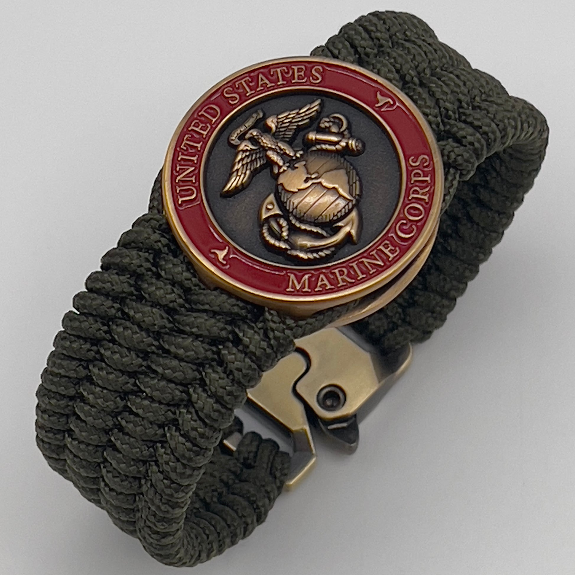 Thin, wide, very flexible and comfortable braided United States Marine Corps bracelet featuring a 24K antique gold plated USMC Eagle Globe and Anchor medallion, a gold Cobra style tactical buckle and woven with OIive Drab Type-1 paracord.