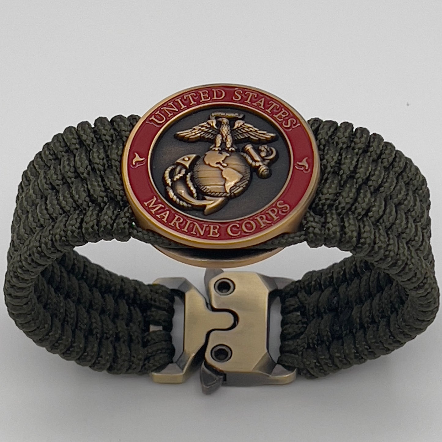 Thin, wide, very flexible and comfortable braided United States Marine Corps bracelet featuring a 24K antique gold plated USMC Eagle Globe and Anchor medallion, a gold Cobra style tactical buckle and woven with OIive Drab Type-1 paracord.