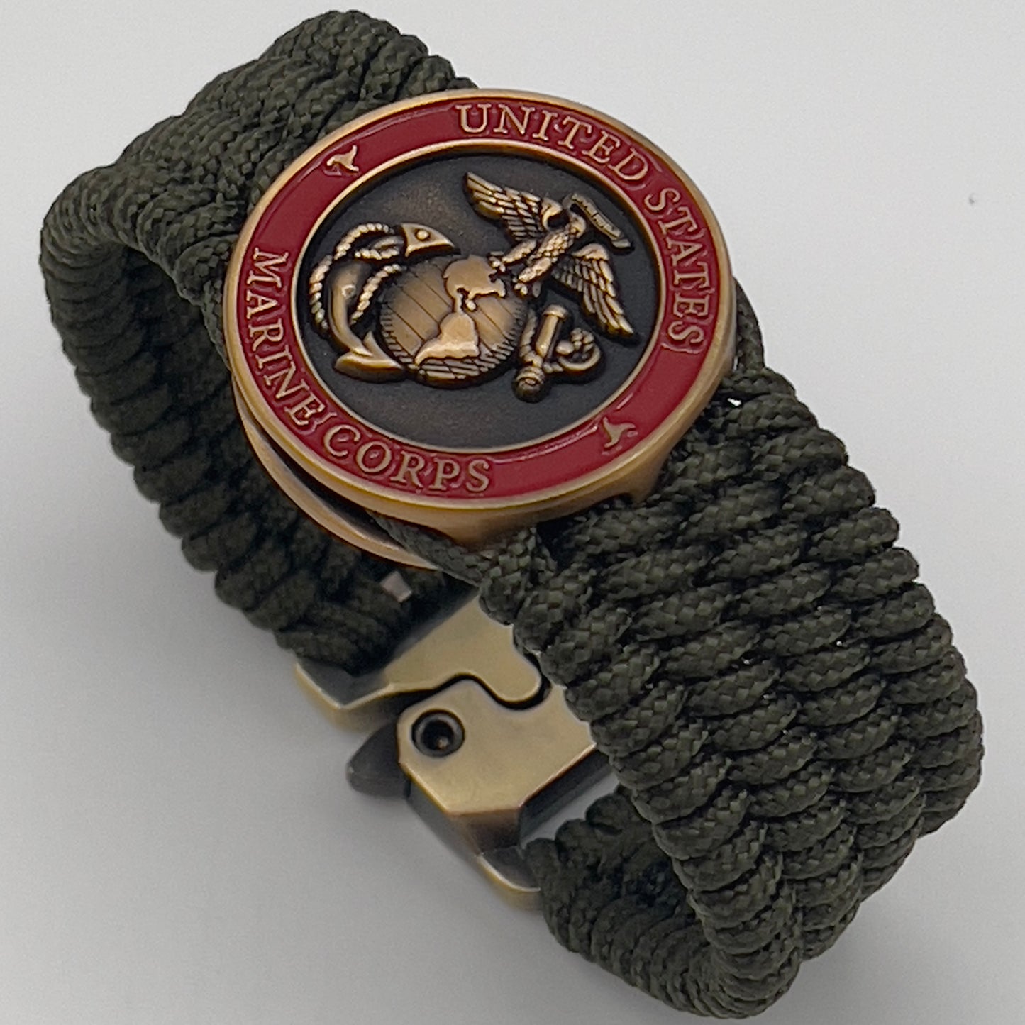 Thin, wide, very flexible and comfortable braided United States Marine Corps bracelet featuring a 24K antique gold plated USMC Eagle Globe and Anchor medallion, a gold Cobra style tactical buckle and woven with OIive Drab Type-1 paracord.