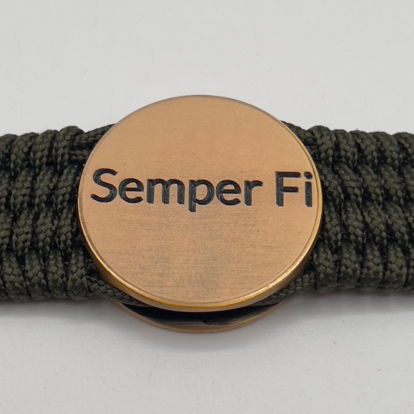 Thin, wide, very flexible and comfortable braided United States Marine Corps bracelet featuring a 24K antique gold plated USMC Eagle Globe and Anchor medallion, a gold Cobra style tactical buckle and woven with OIive Drab Type-1 paracord.