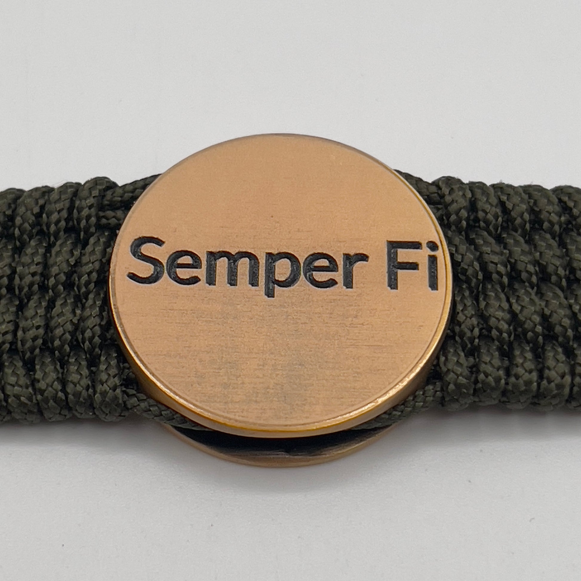 Thin, wide, very flexible and comfortable braided United States Marine Corps bracelet featuring a 24K antique gold plated USMC Eagle Globe and Anchor medallion, a gold Cobra style tactical buckle and woven with OIive Drab Type-1 paracord.