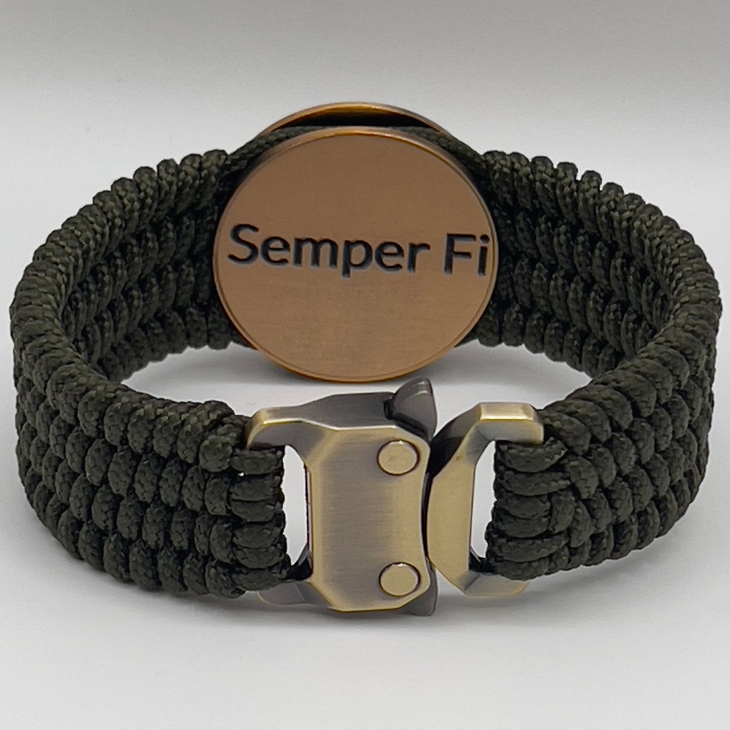Thin, wide, very flexible and comfortable braided United States Marine Corps bracelet featuring a 24K antique gold plated USMC Eagle Globe and Anchor medallion, a gold Cobra style tactical buckle and woven with OIive Drab Type-1 paracord.