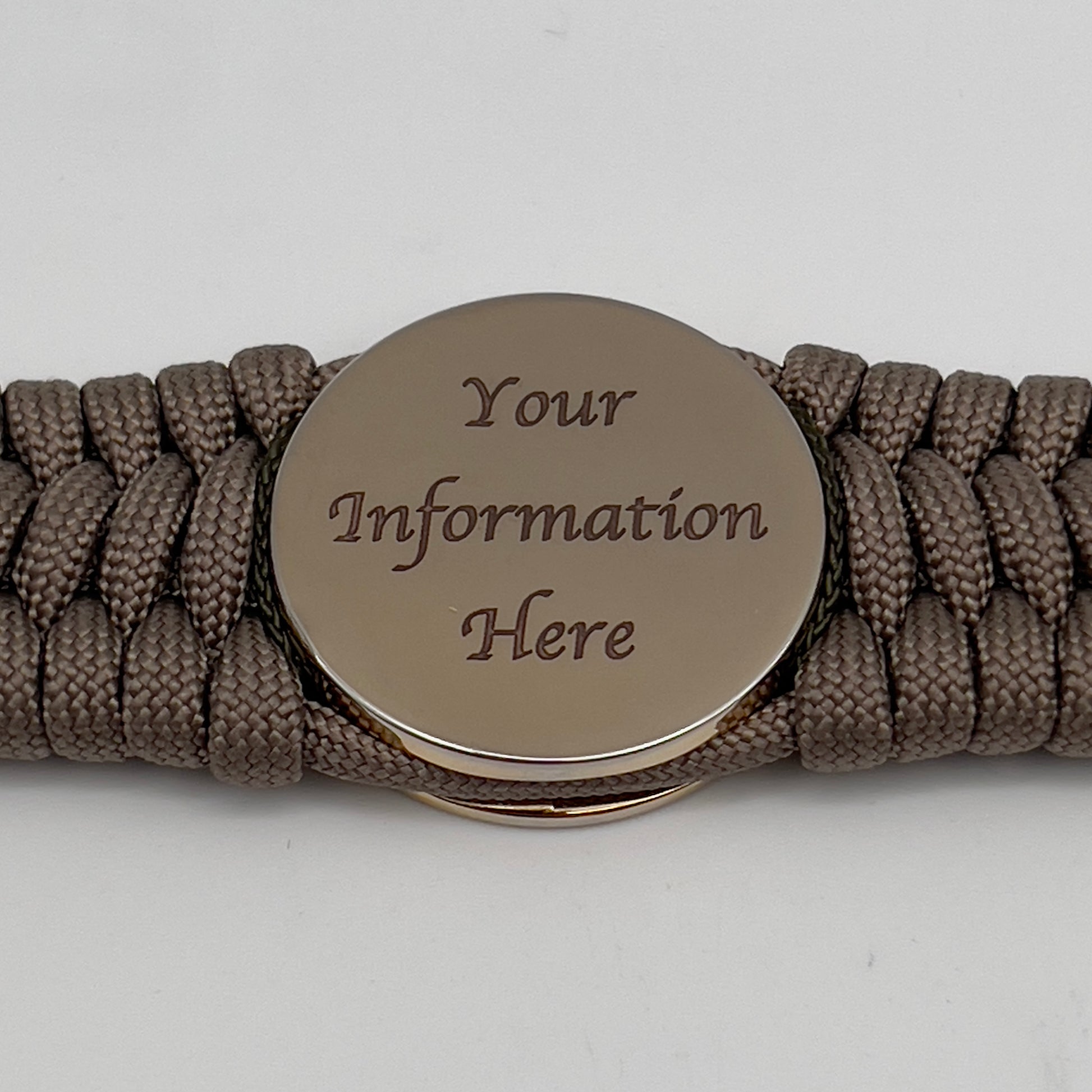 Thick, wide, rigid and comfortable braided United States Marine Corps bracelet featuring a 24K gold plated USMC Eagle Globe and Anchor medallion, a gold Cobra style tactical buckle and woven with tan 550 paracord and olive drab nano and micro cord.
