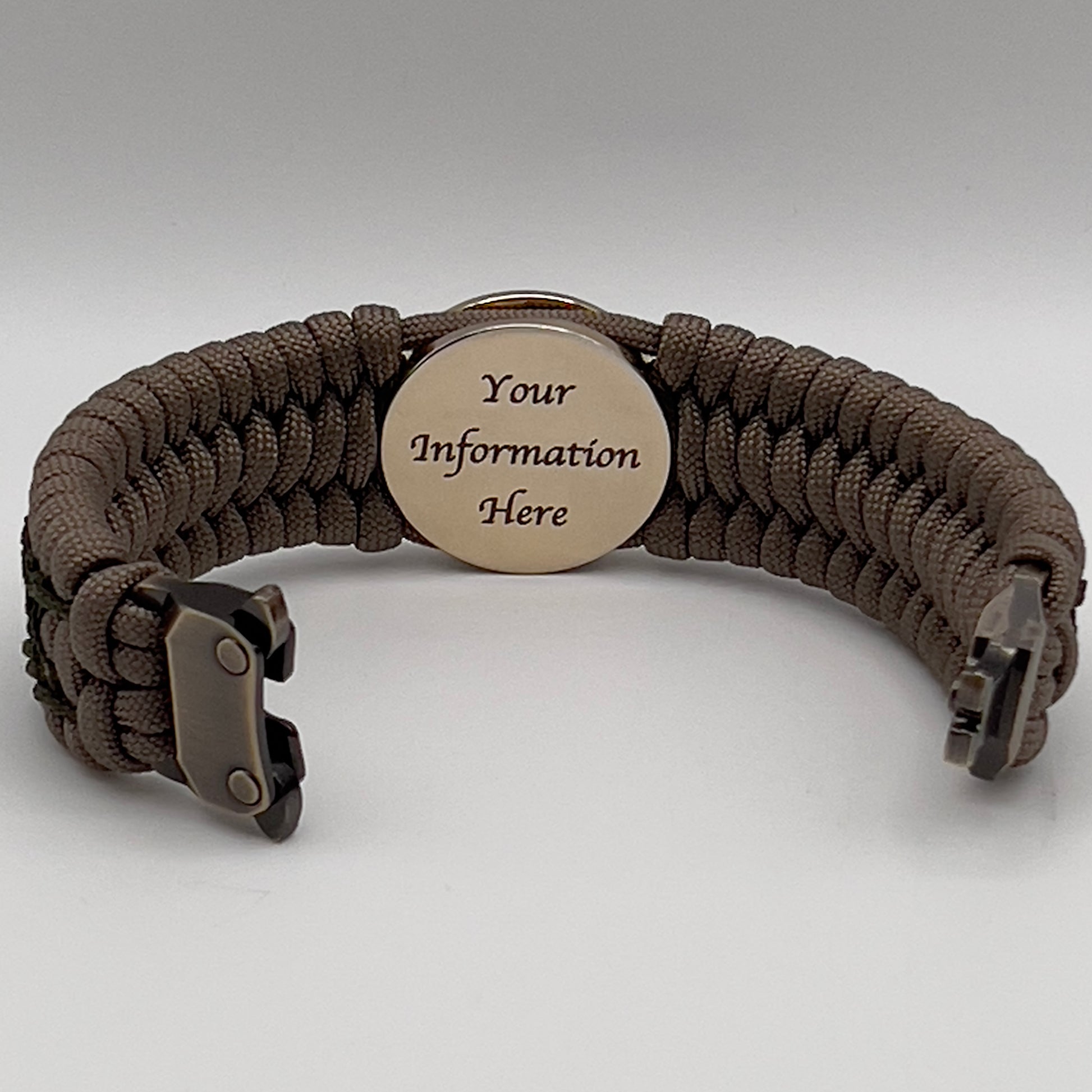 Thick, wide, rigid and comfortable braided United States Marine Corps bracelet featuring a 24K gold plated USMC Eagle Globe and Anchor medallion, a gold Cobra style tactical buckle and woven with tan 550 paracord and olive drab nano and micro cord.