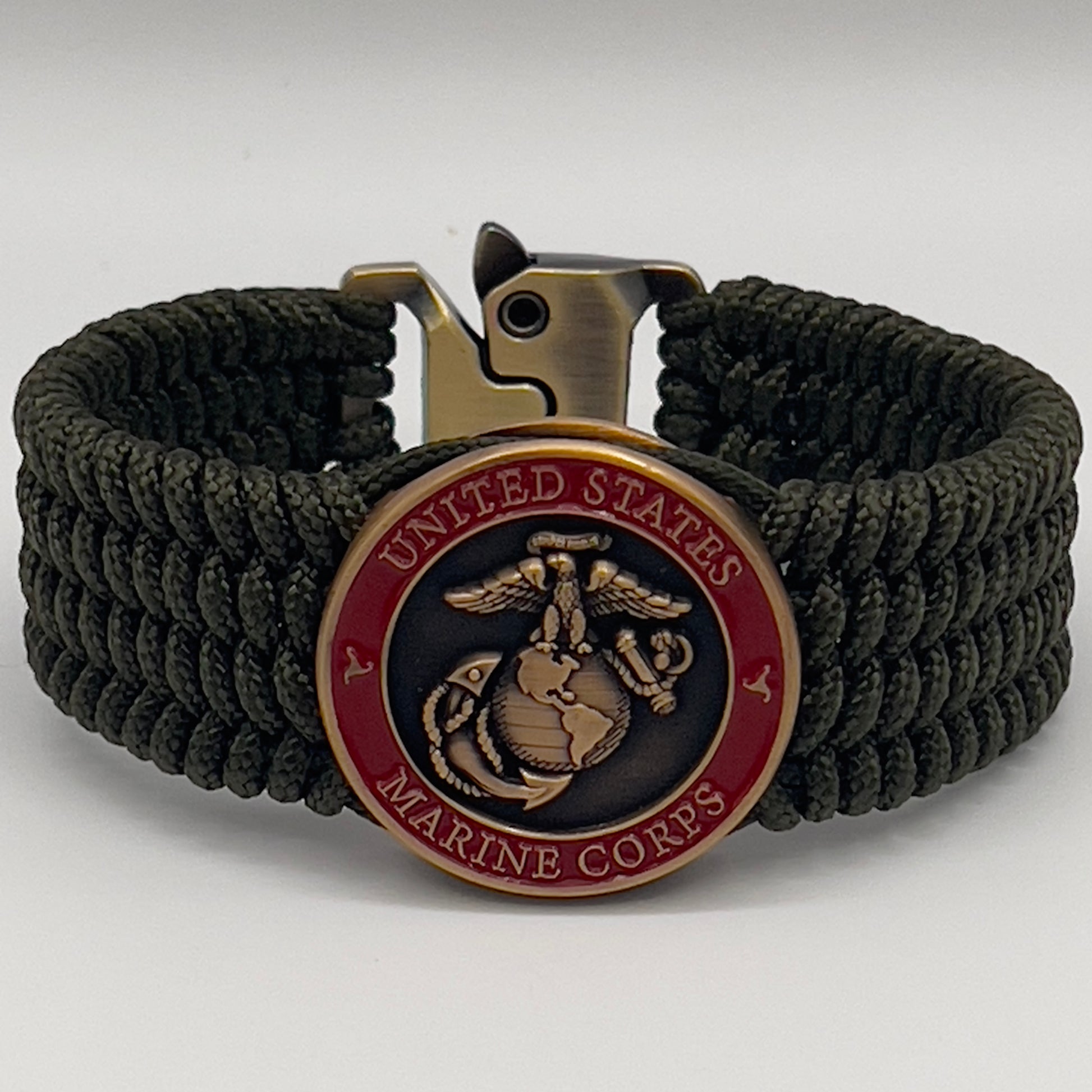 Thin, wide, very flexible and comfortable braided United States Marine Corps bracelet featuring a 24K antique gold plated USMC Eagle Globe and Anchor medallion, a gold Cobra style tactical buckle and woven with OIive Drab Type-1 paracord.