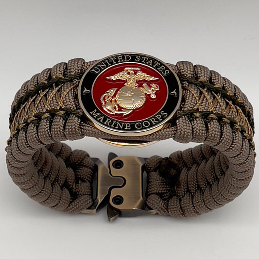 Thick, wide, rigid and comfortable braided United States Marine Corps bracelet featuring a 24K gold plated USMC Eagle Globe and Anchor medallion, a gold Cobra style tactical buckle and woven with tan 550 paracord and olive drab micro and tan nano cord.