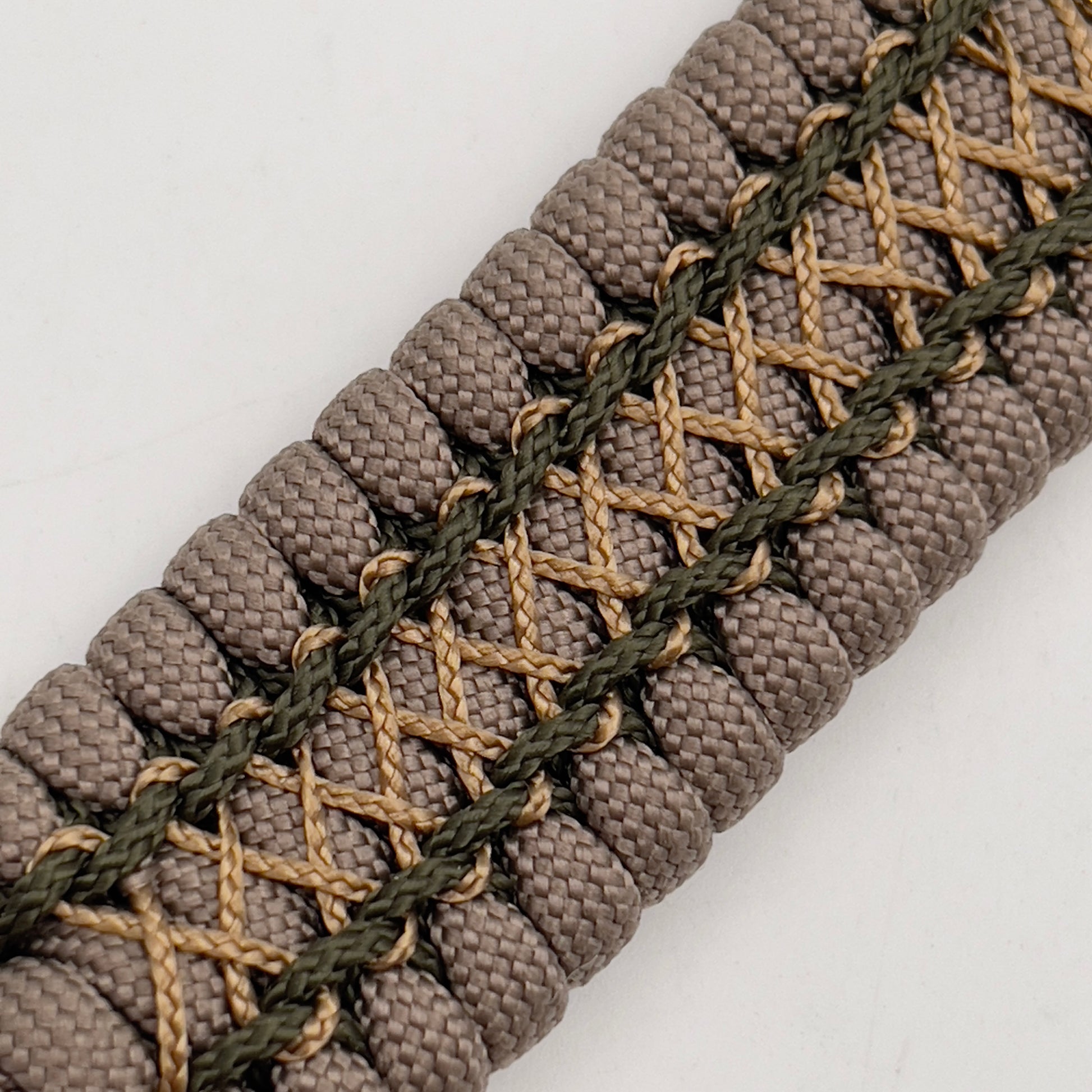 Thick, wide, rigid and comfortable braided United States Marine Corps bracelet featuring a 24K gold plated USMC Eagle Globe and Anchor medallion, a gold Cobra style tactical buckle and woven with tan 550 paracord and olive drab micro and tan nano cord.