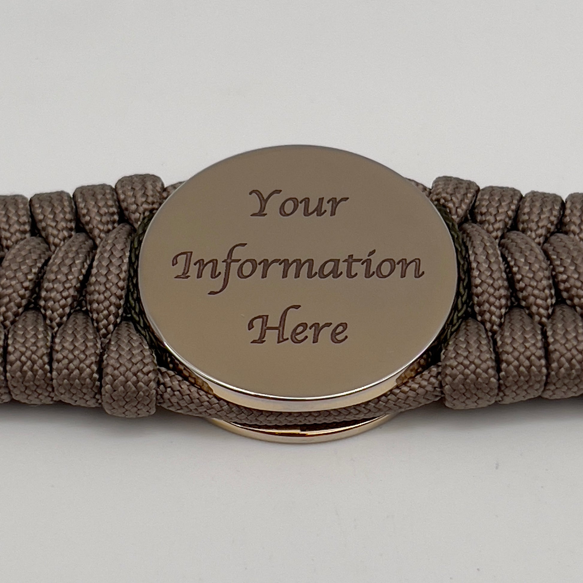 Thick, wide, rigid and comfortable braided United States Marine Corps bracelet featuring a 24K gold plated USMC Eagle Globe and Anchor medallion, a gold Cobra style tactical buckle and woven with tan 550 paracord and olive drab micro and tan nano cord.
