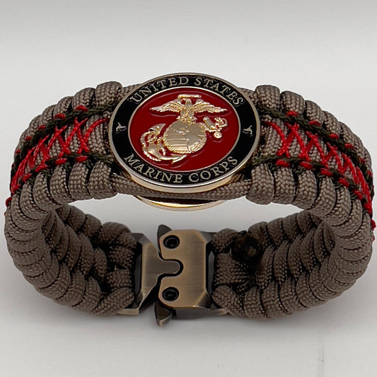 Thick, wide, rigid and comfortable braided United States Marine Corps bracelet featuring a 24K gold plated USMC Eagle Globe and Anchor medallion, a gold Cobra style tactical buckle and woven with tan 550 paracord, olive drab micro and Imperial red nano cord.
