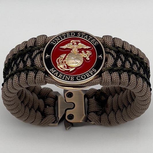 Thick, wide, rigid and comfortable braided United States Marine Corps bracelet featuring a 24K gold plated USMC Eagle Globe and Anchor medallion, a gold Cobra style tactical buckle and woven with tan 550 paracord, olive drab micro and black nano cord.