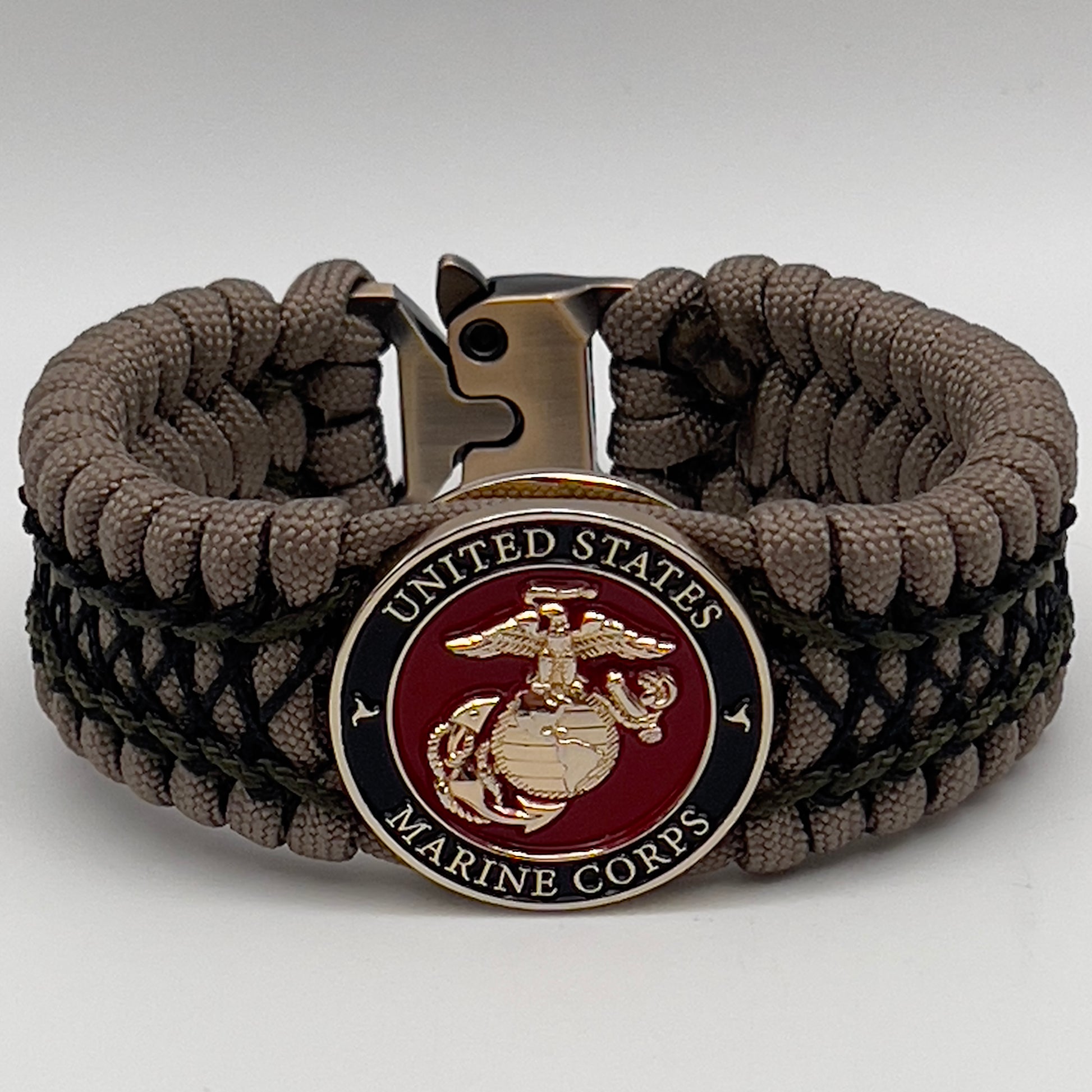 Thick, wide, rigid and comfortable braided United States Marine Corps bracelet featuring a 24K gold plated USMC Eagle Globe and Anchor medallion, a gold Cobra style tactical buckle and woven with tan 550 paracord, olive drab micro and black nano cord.