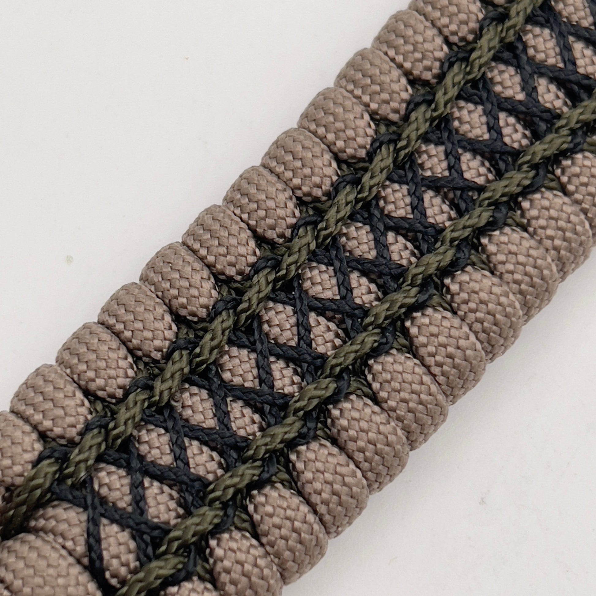 Thick, wide, rigid and comfortable braided United States Marine Corps bracelet featuring a 24K gold plated USMC Eagle Globe and Anchor medallion, a gold Cobra style tactical buckle and woven with tan 550 paracord, olive drab micro and black nano cord.