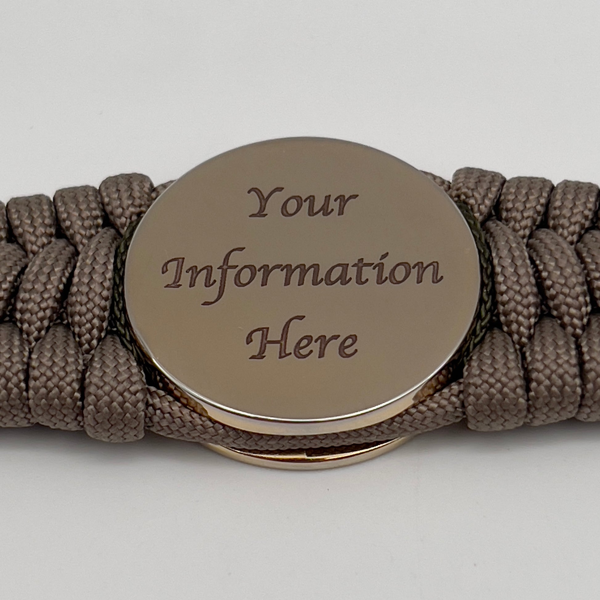 Thick, wide, rigid and comfortable braided United States Marine Corps bracelet featuring a 24K gold plated USMC Eagle Globe and Anchor medallion, a gold Cobra style tactical buckle and woven with tan 550 paracord, olive drab micro and black nano cord.