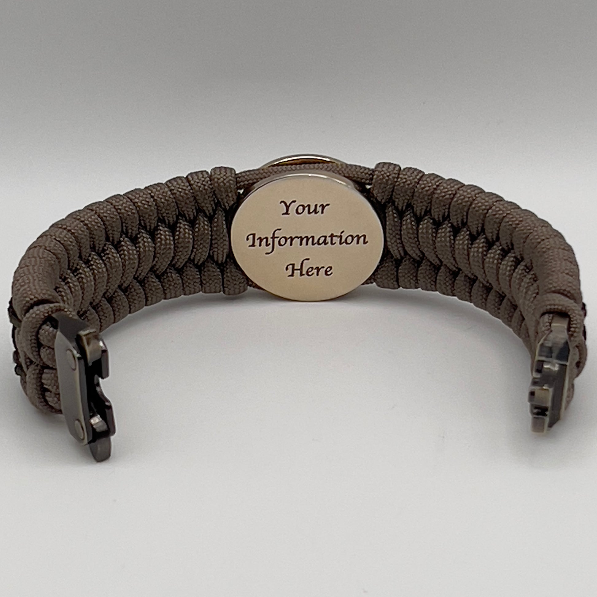 Thick, wide, rigid and comfortable braided United States Marine Corps bracelet featuring a 24K gold plated USMC Eagle Globe and Anchor medallion, a gold Cobra style tactical buckle and woven with tan 550 paracord, olive drab micro and black nano cord.