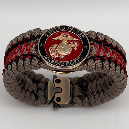 Thick, wide, rigid and comfortable handwoven United States Marine Corps bracelet featuring a 24K gold plated USMC Eagle Globe and Anchor medallion, a gold Cobra style tactical buckle and woven with tna 550 paracord, black micro cord and red nano cord.