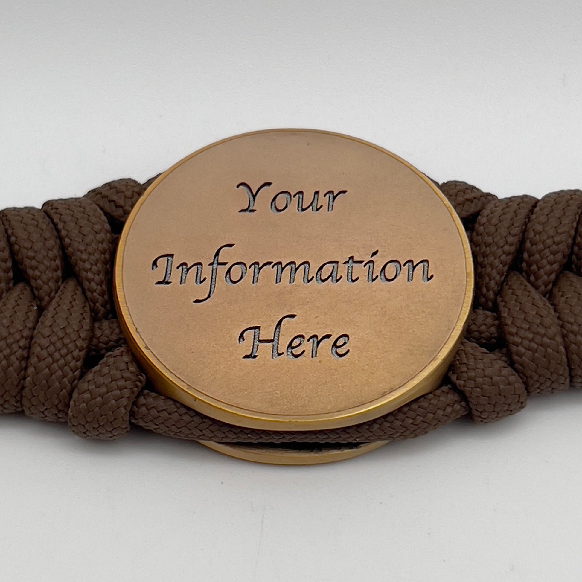 Thick, medium width, semi-rigid and comfortable braided United States Marine Corps bracelet featuring a 24K antique gold plated USMC Eagle Globe and Anchor medallion, a gold Cobra style tactical buckle and woven with Coyote Brown 550 paracord 