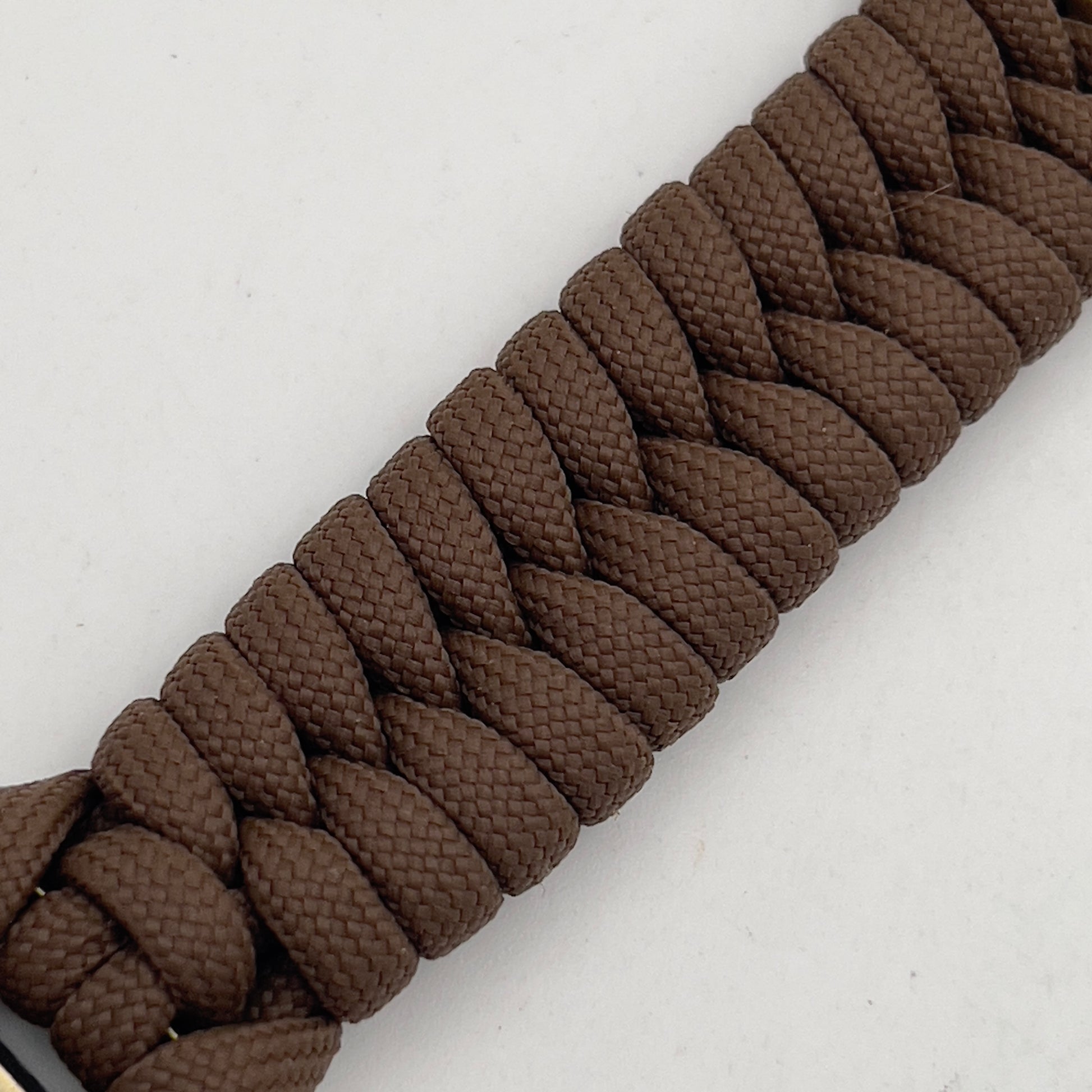 Thick, medium width, semi-rigid and comfortable braided United States Marine Corps bracelet featuring a 24K antique gold plated USMC Eagle Globe and Anchor medallion, a gold Cobra style tactical buckle and woven with Coyote Brown 550 paracord 