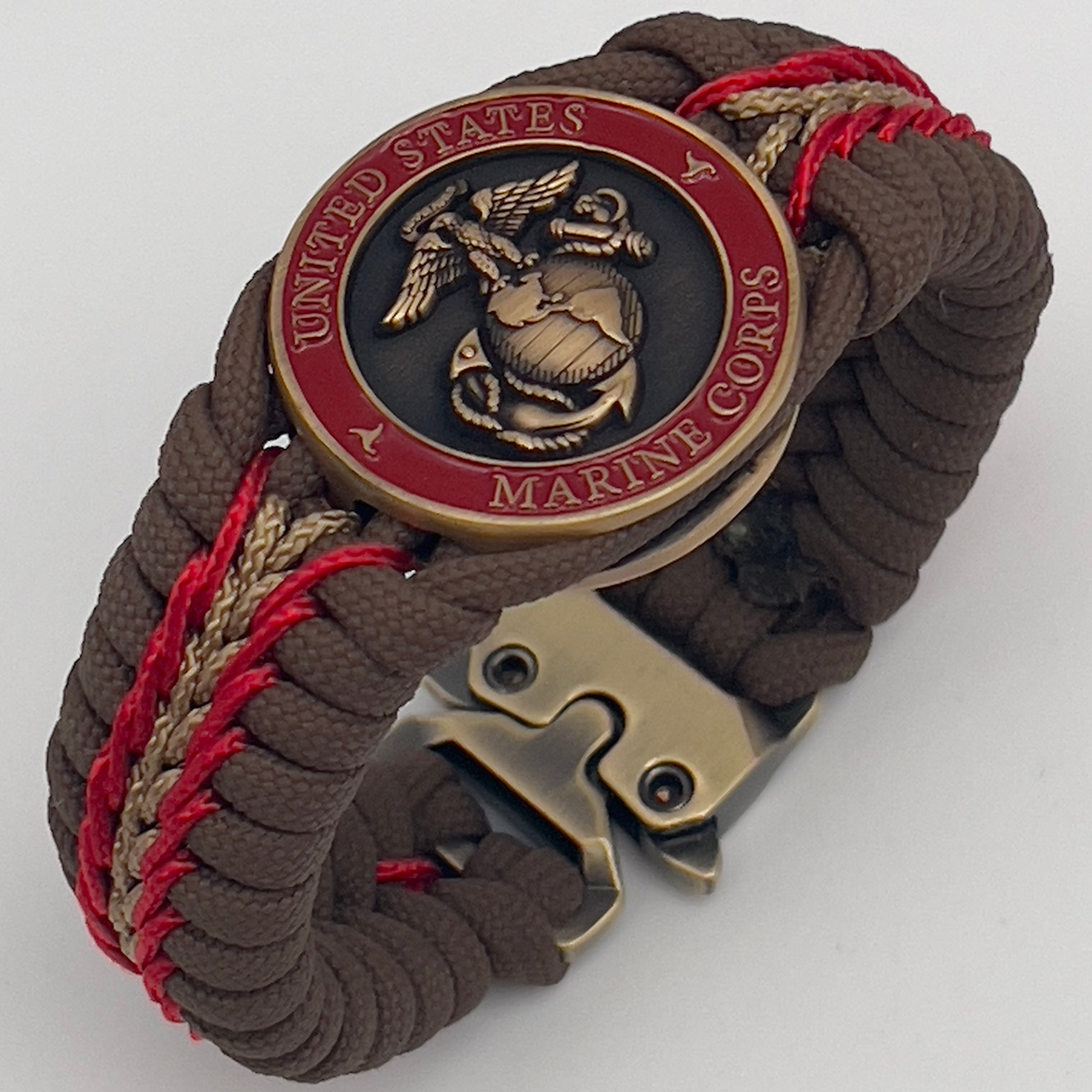 Thick, medium width, rigid and comfortable braided United States Marine Corps bracelet featuring a 24K antique gold plated USMC Eagle Globe and Anchor medallion, a gold Cobra style tactical buckle and woven with Coyote Brown 550 paracord and Imperial Red and Gold micro cord.