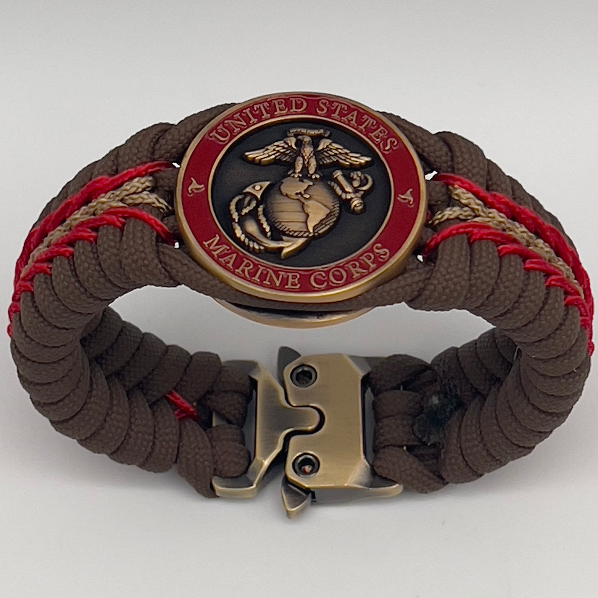 Thick, medium width, rigid and comfortable braided United States Marine Corps bracelet featuring a 24K antique gold plated USMC Eagle Globe and Anchor medallion, a gold Cobra style tactical buckle and woven with Coyote Brown 550 paracord and Imperial Red and Gold micro cord.