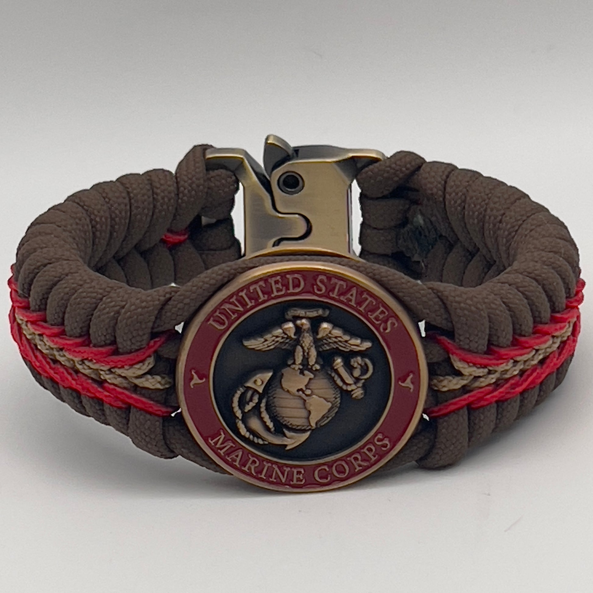 Thick, medium width, rigid and comfortable braided United States Marine Corps bracelet featuring a 24K antique gold plated USMC Eagle Globe and Anchor medallion, a gold Cobra style tactical buckle and woven with Coyote Brown 550 paracord and Imperial Red and Gold micro cord.