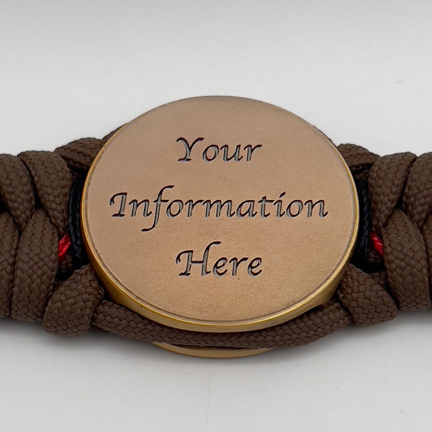 Thick, medium width, rigid and comfortable braided United States Marine Corps bracelet featuring a 24K antique gold plated USMC Eagle Globe and Anchor medallion, a gold Cobra style tactical buckle and woven with Coyote Brown 550 paracord and Imperial Red and Black micro cord.