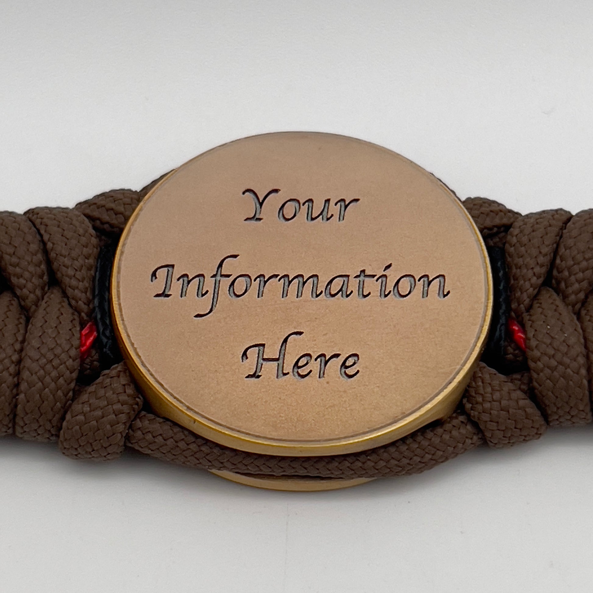 Thick, medium width, rigid and comfortable braided United States Marine Corps bracelet featuring a 24K antique gold plated USMC Eagle Globe and Anchor medallion, a gold Cobra style tactical buckle and woven with Coyote Brown 550 paracord and Imperial Red and Black micro cord.