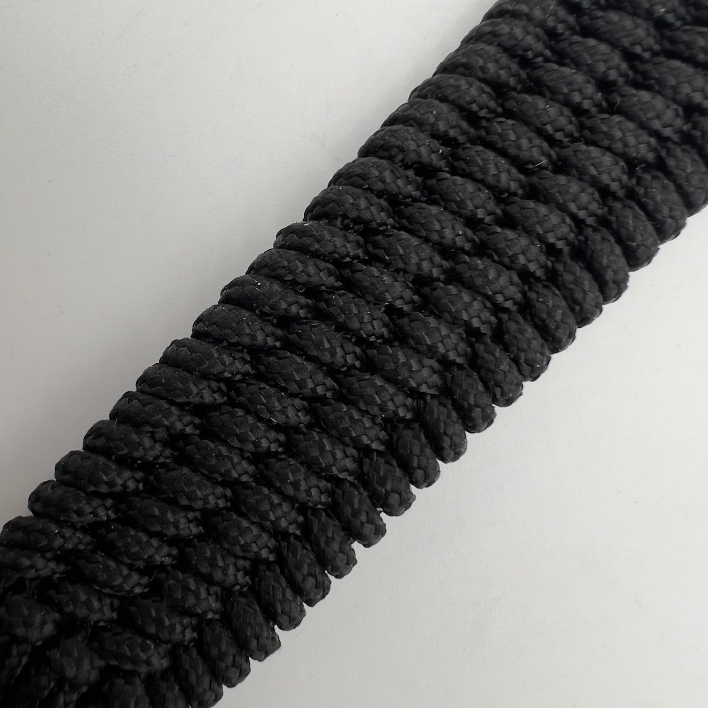 Thin, medium wide, very thin and flexible and comfortable braided United States Marine Corps bracelet featuring a 24K antique gold plated USMC Eagle Globe and Anchor medallion, a black Cobra style tactical buckle and woven with black Type-1 paracord.