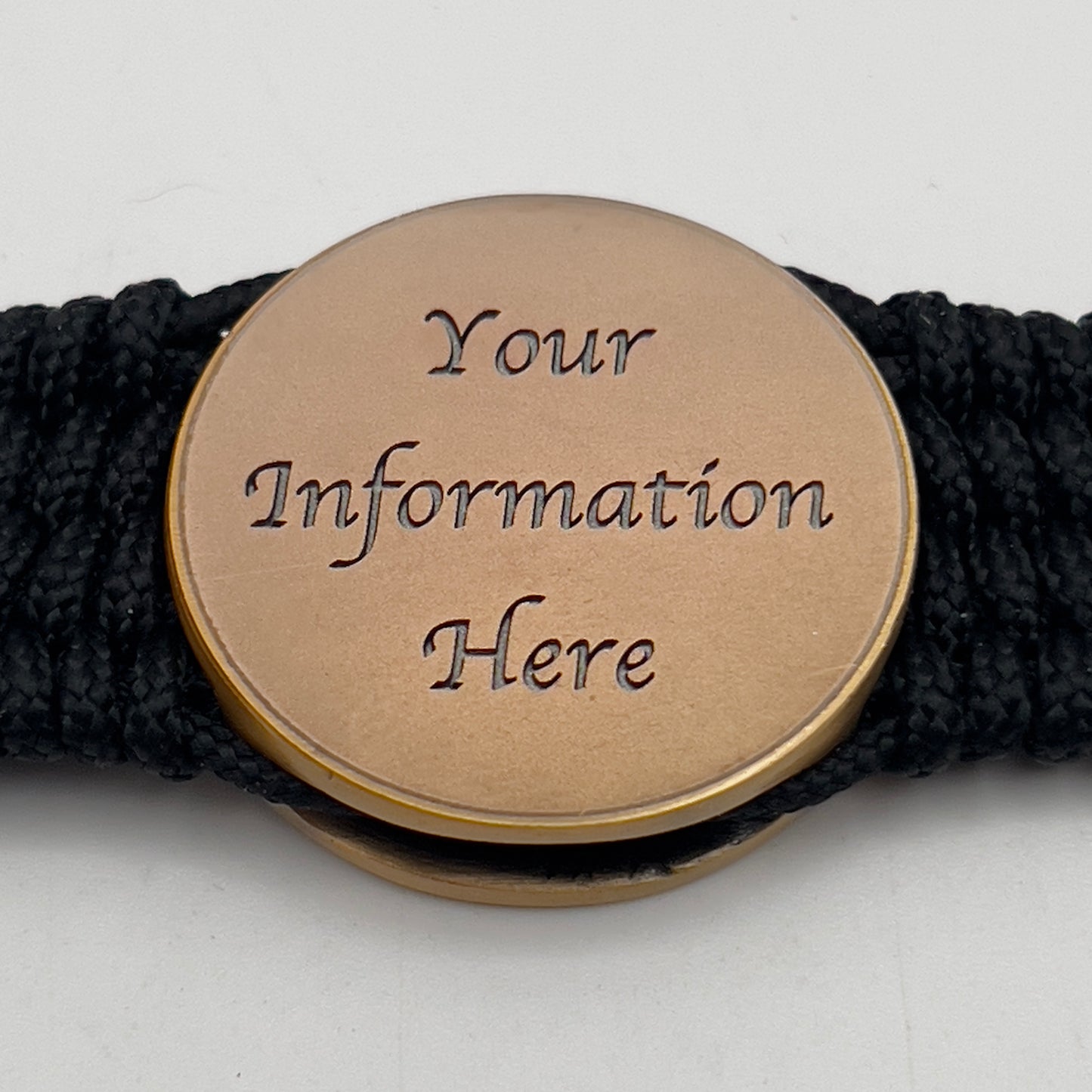 Thin, medium wide, very thin and flexible and comfortable braided United States Marine Corps bracelet featuring a 24K antique gold plated USMC Eagle Globe and Anchor medallion, a black Cobra style tactical buckle and woven with black Type-1 paracord.